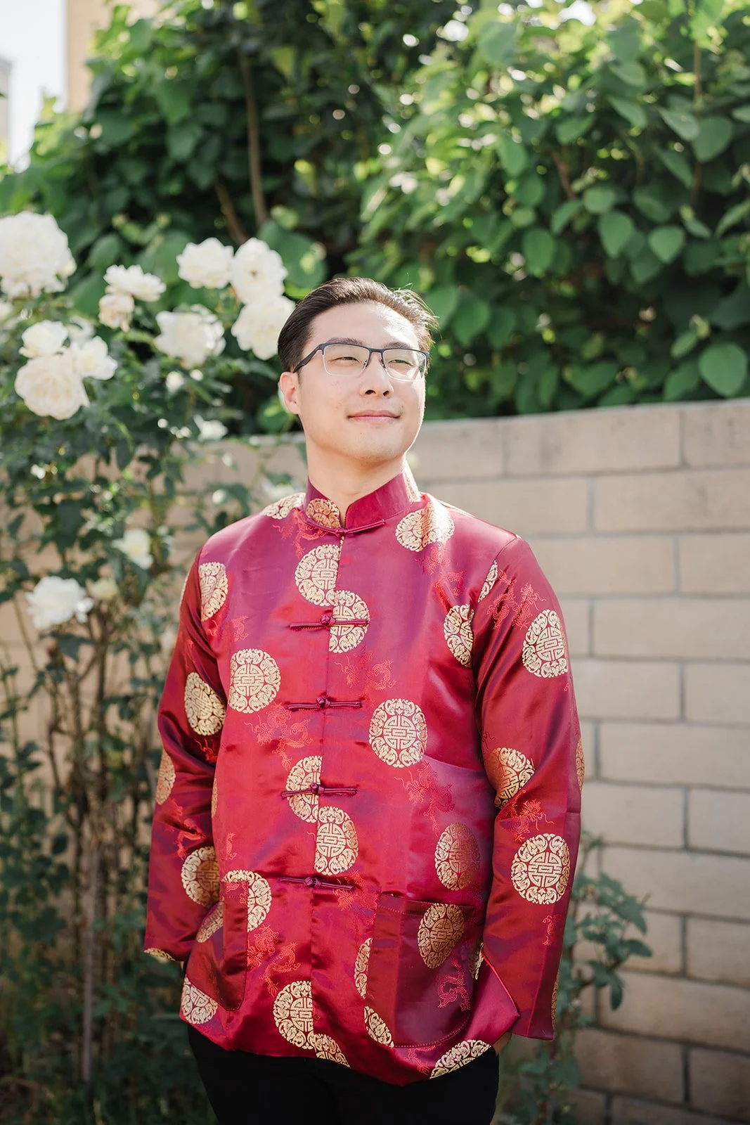 Danny smiling in his red jacket, photographed by One and Only Production.