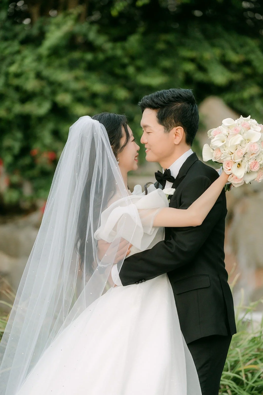 Eunsang holding Jeannie close beside the waterfall