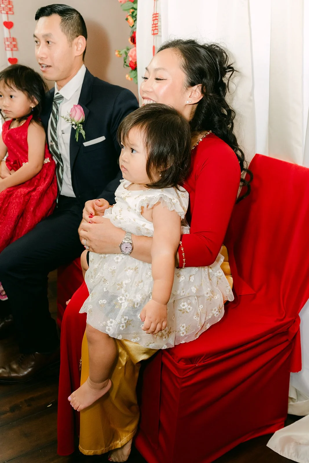 Relatives seated with Vanessa's niece in her white dress.