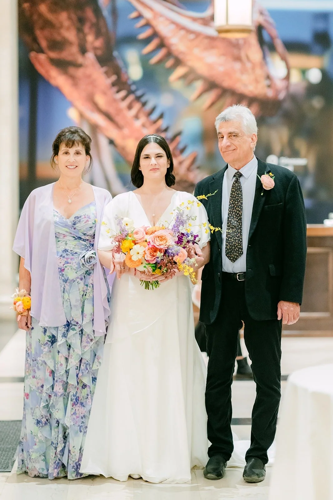 Jessie walking down the aisle with two family members