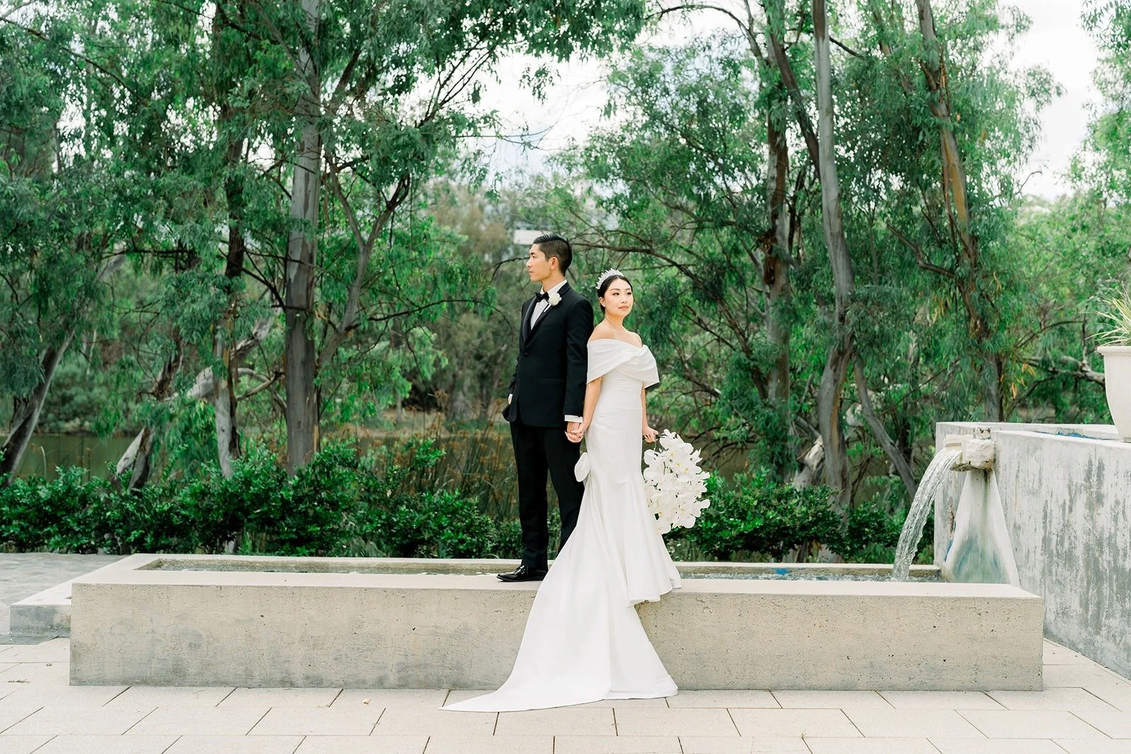 Steven and Jacinda beside a fountain in the garden