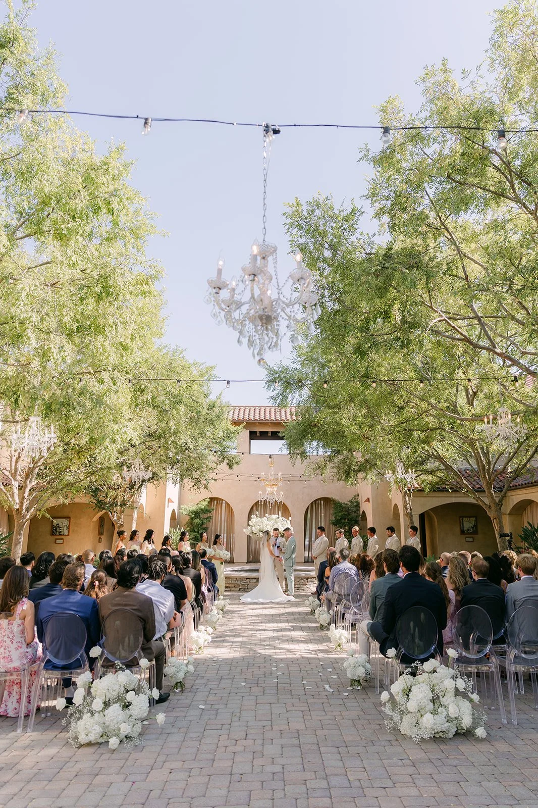 Wide view down the aisle toward the arches with the chandelier overhead