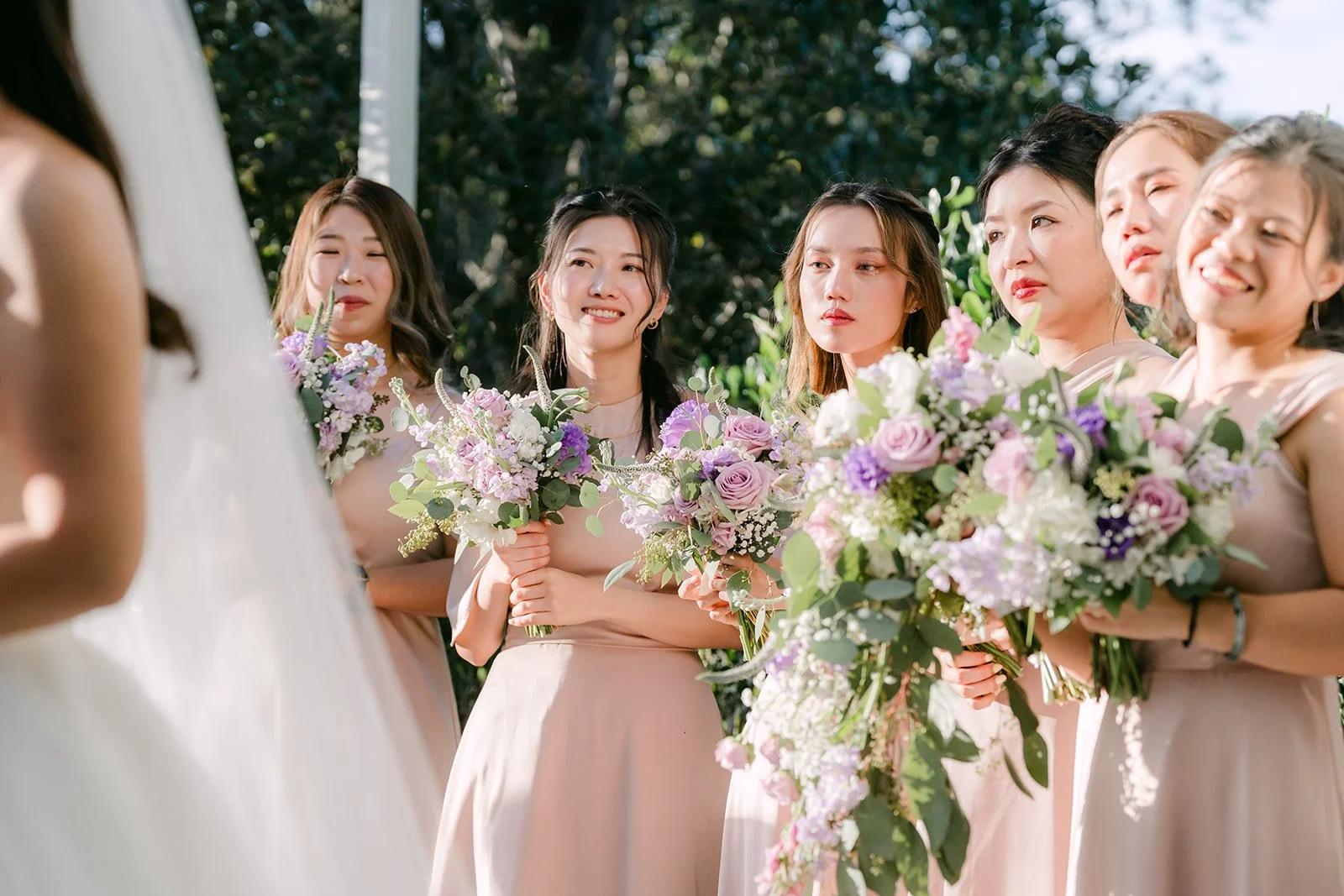 Kate's bridesmaids standing with their bouquets during the ceremony.