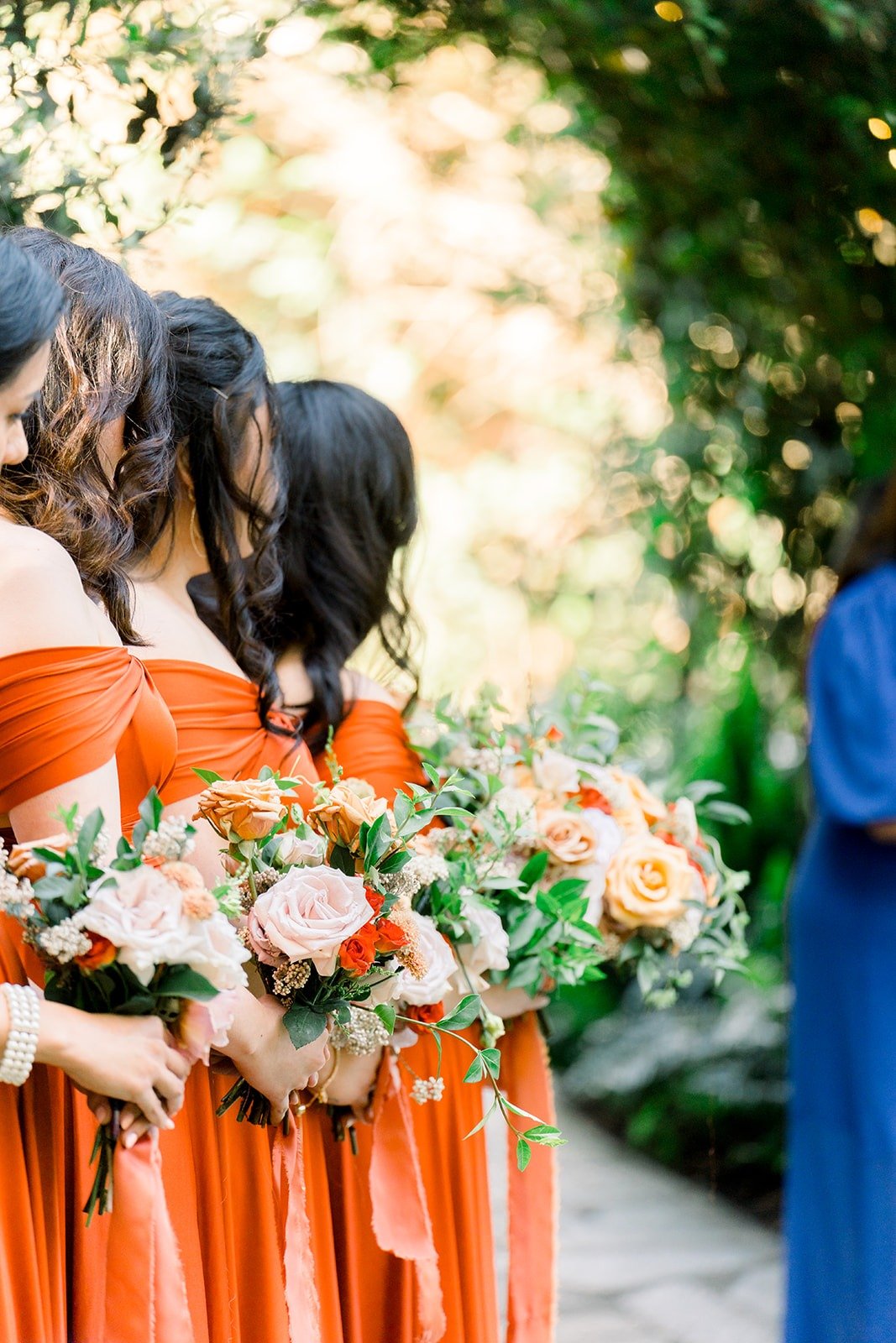 Bridesmaids holding their bouquets during the vows
