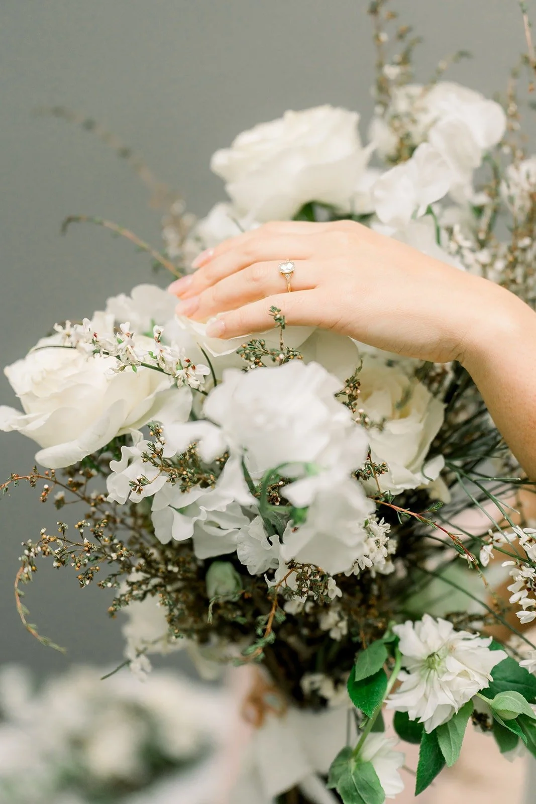 Close up of Cindy's hand and ring on her bouquet