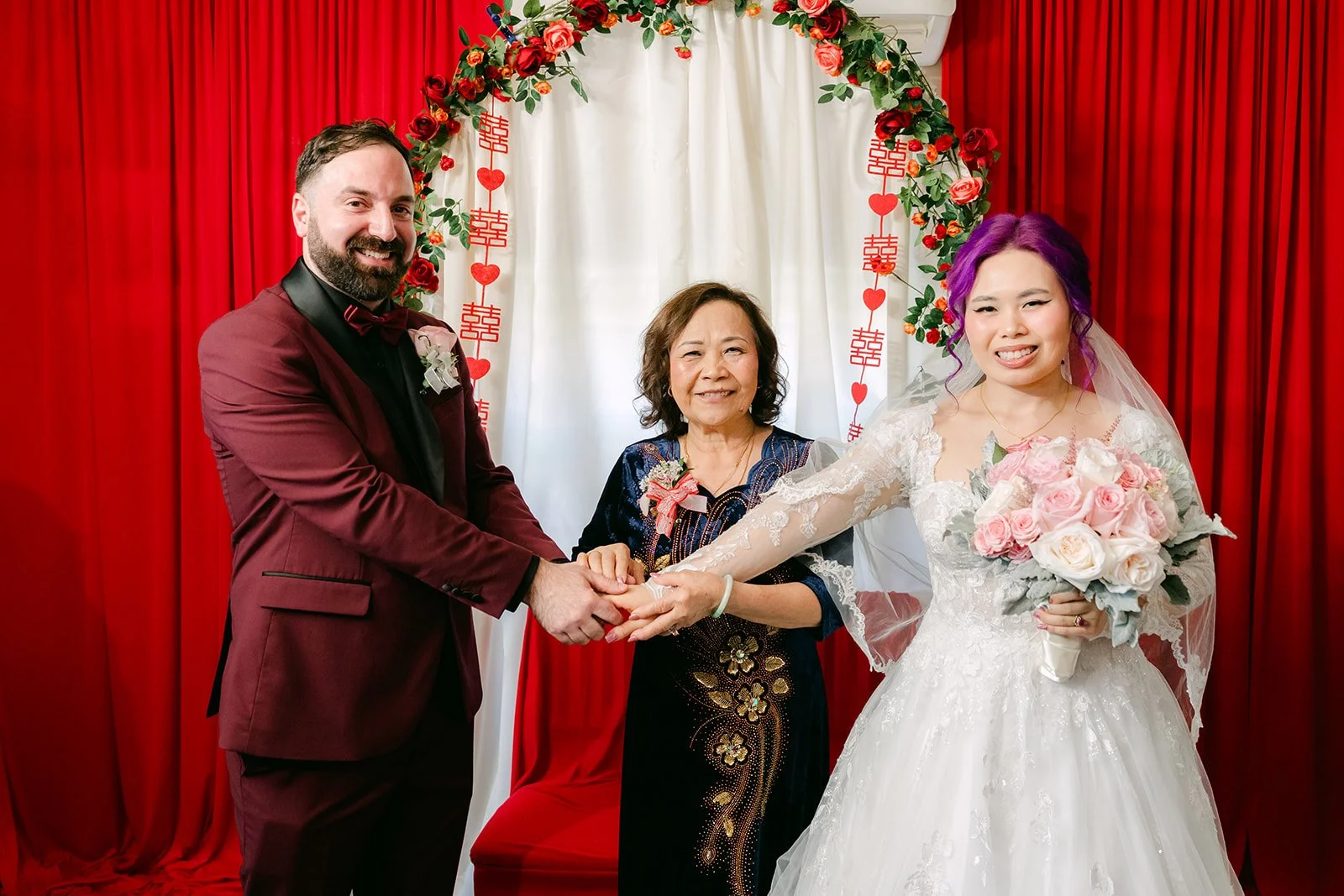 Vanessa's mom handing Vanessa to Ryan at the rose arch.