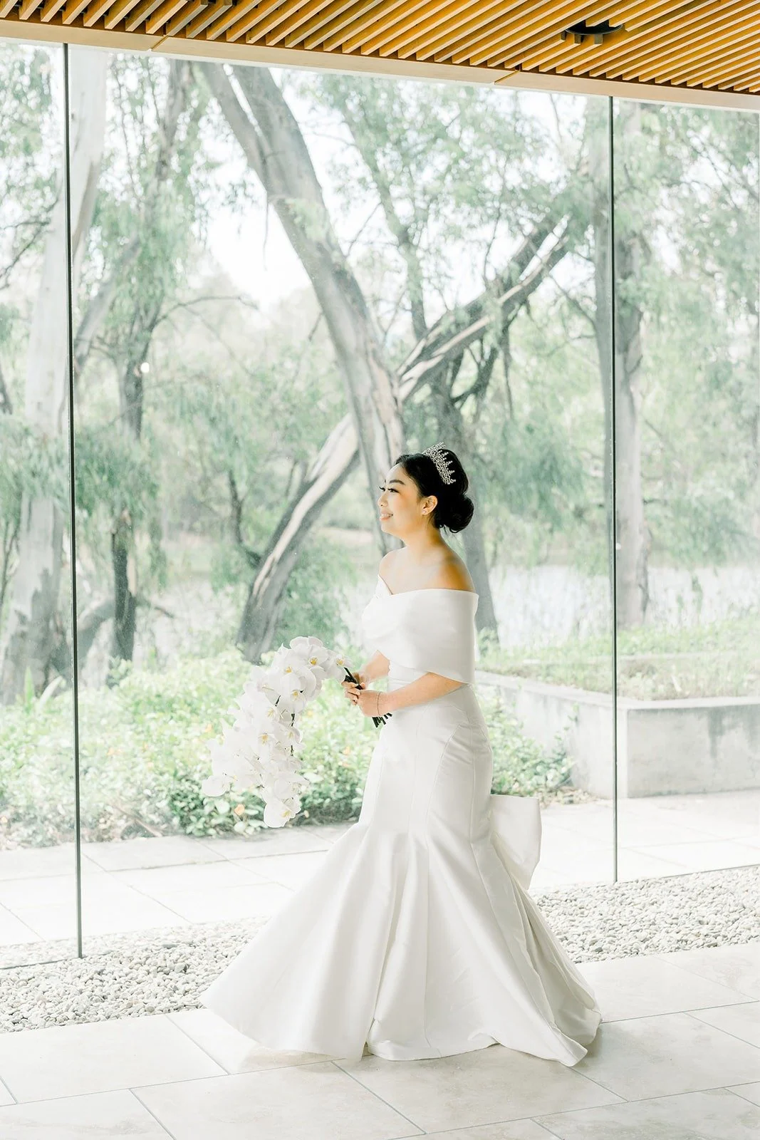 Jacinda walks up to Steven in the glass walled hall for the first look