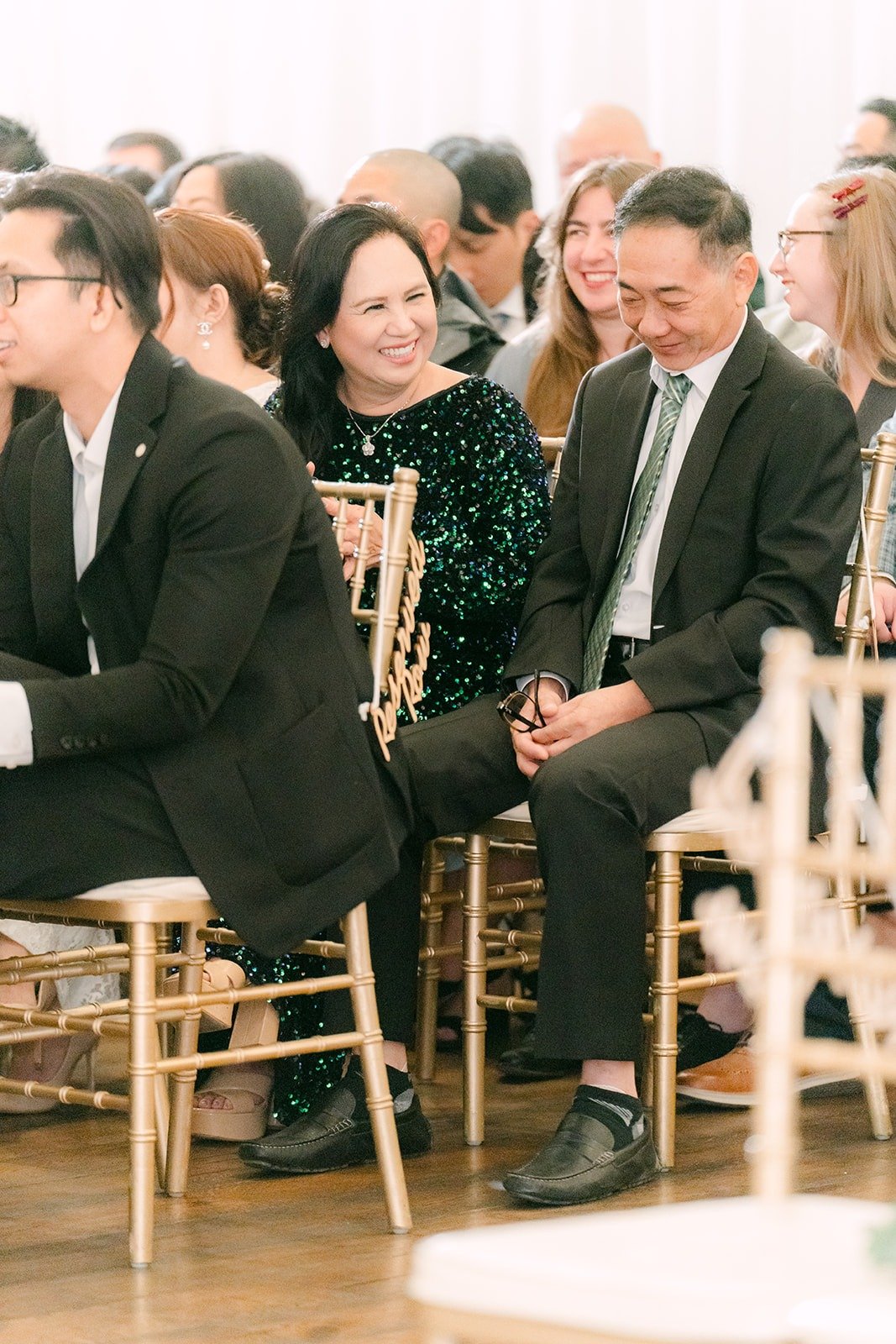 Family smiling from their seats before the ceremony