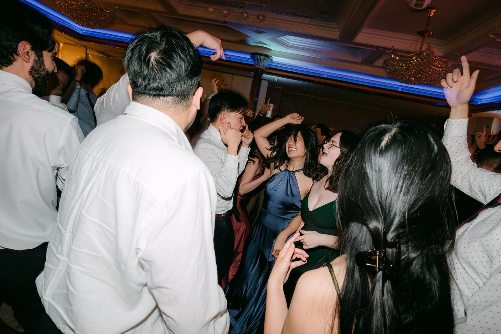 Friends dance in a tight circle