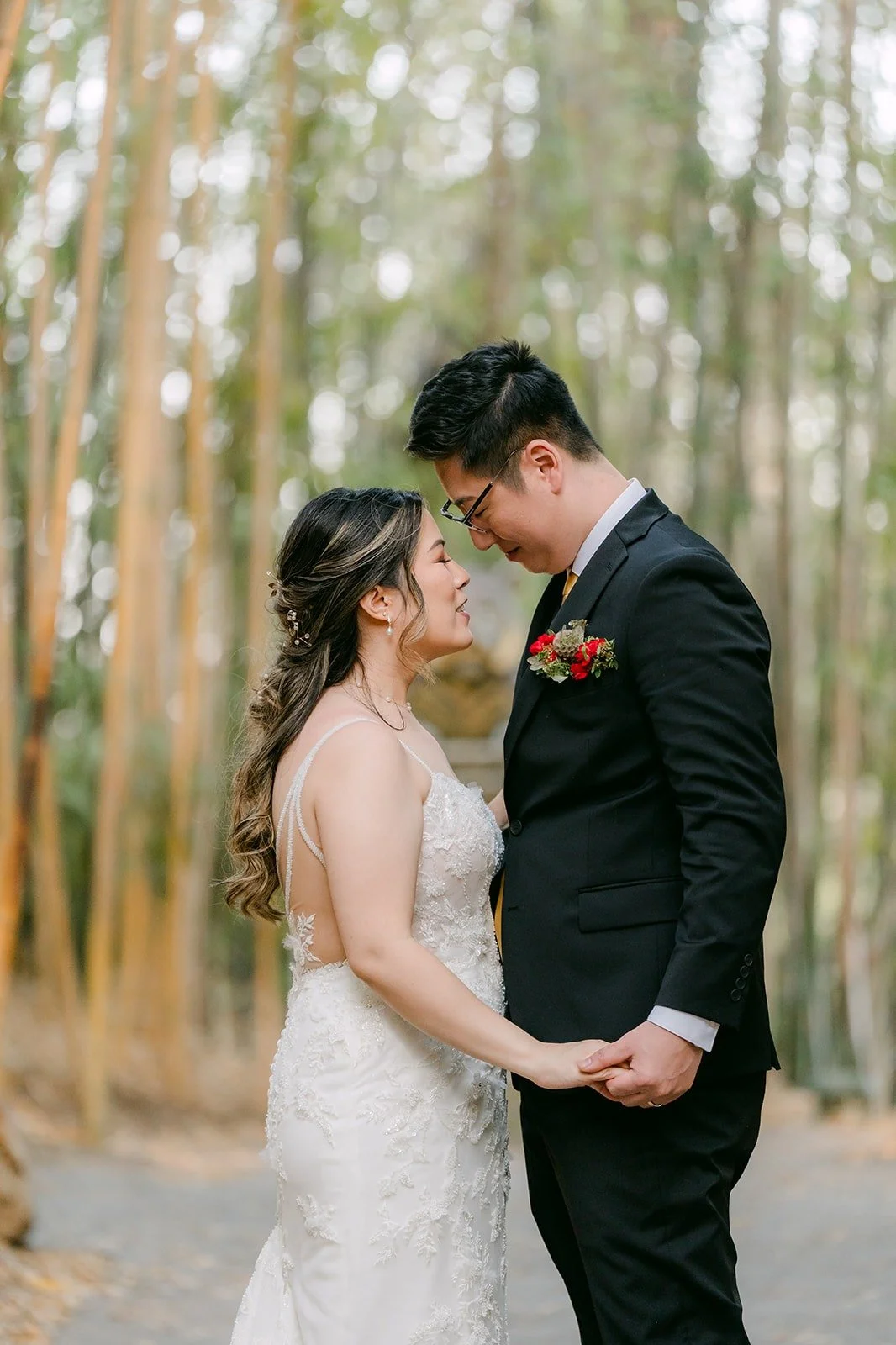 Joanne and Zach resting their foreheads together in the bamboo forest
