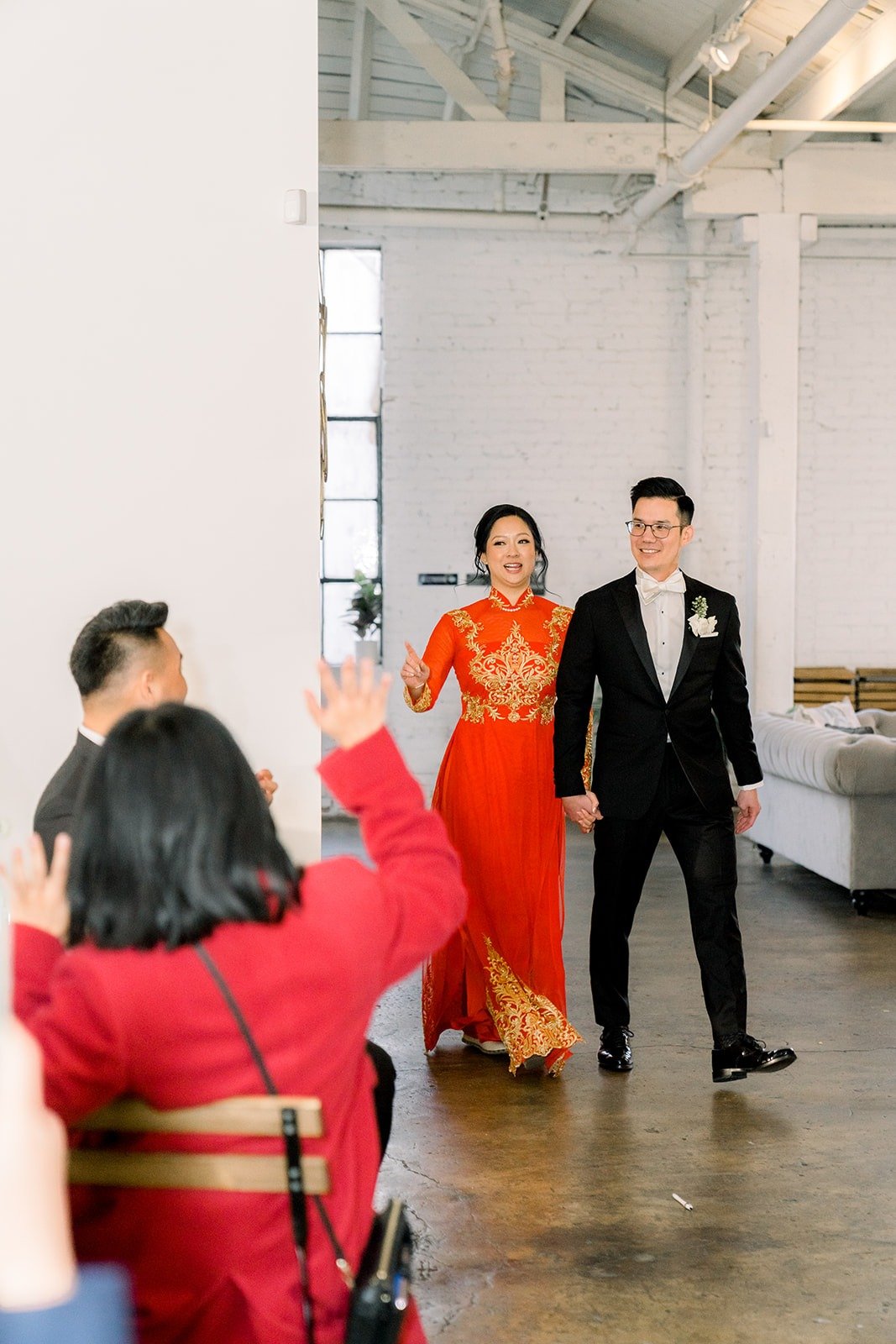 Cindy, now in a red embroidered dress, makes her entrance with Alex