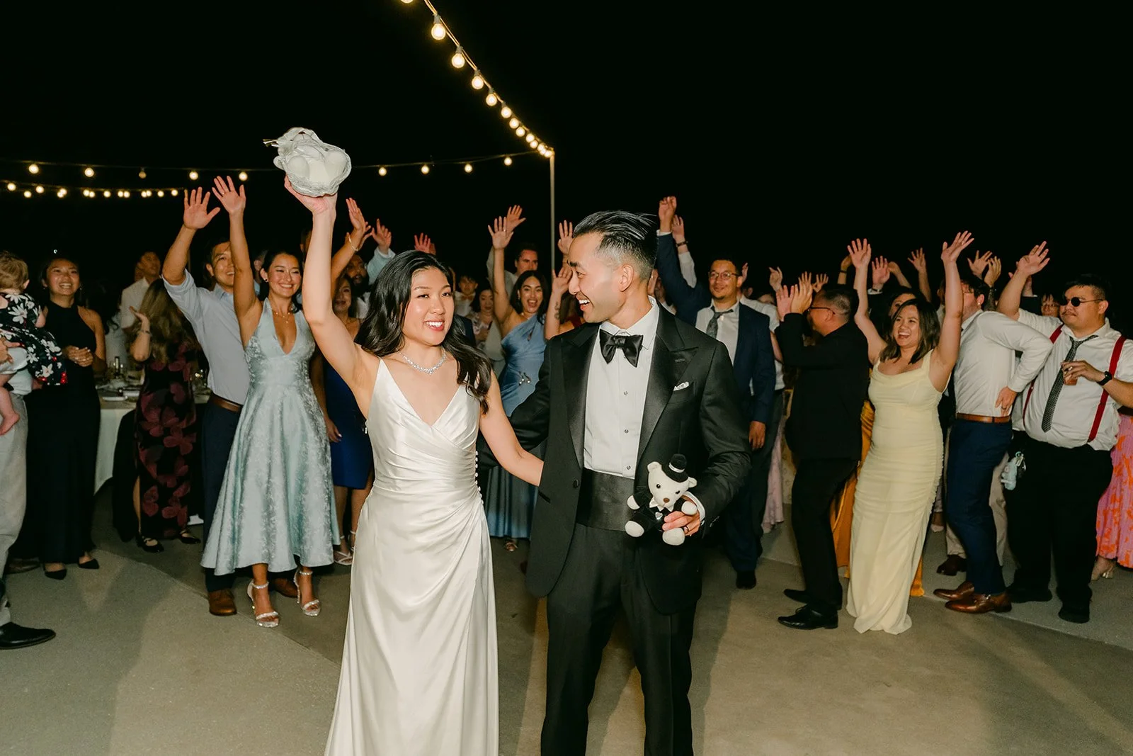 Kim tossing her bouquet on the patio