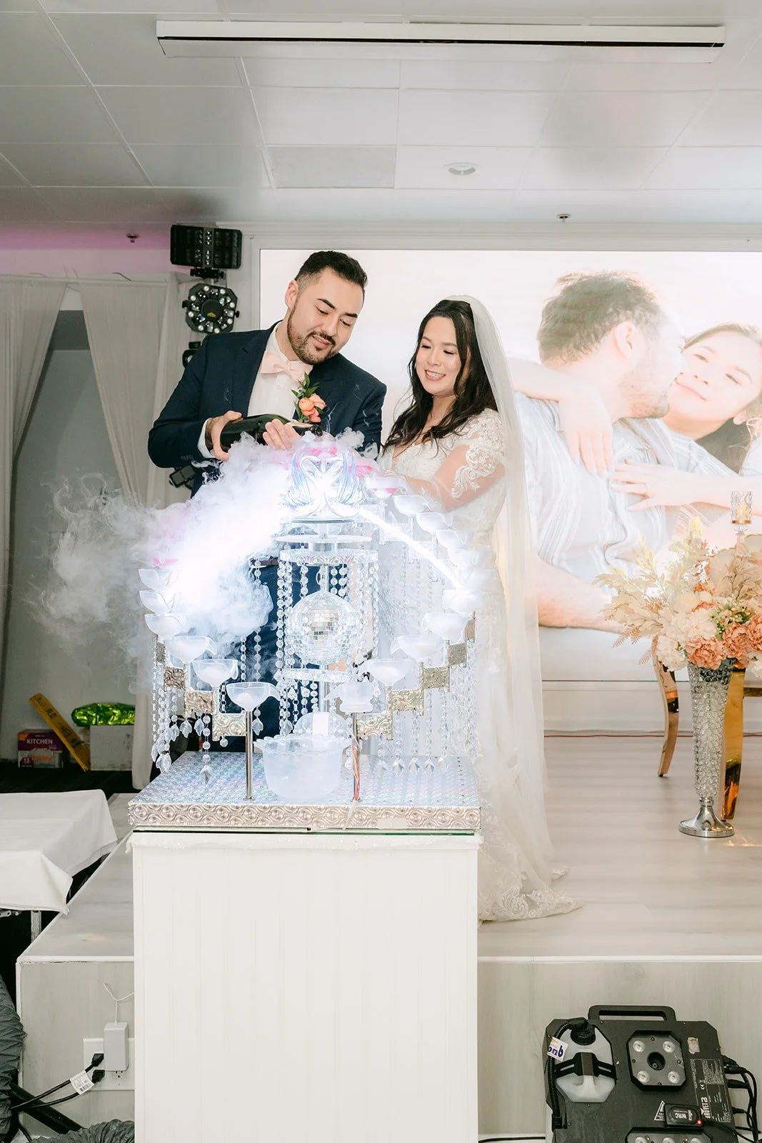 James pouring champagne inside the lit crystal display