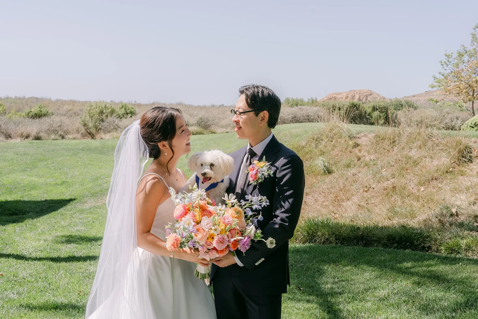 Saya and Leroy with their dog and bouquet on the bluff