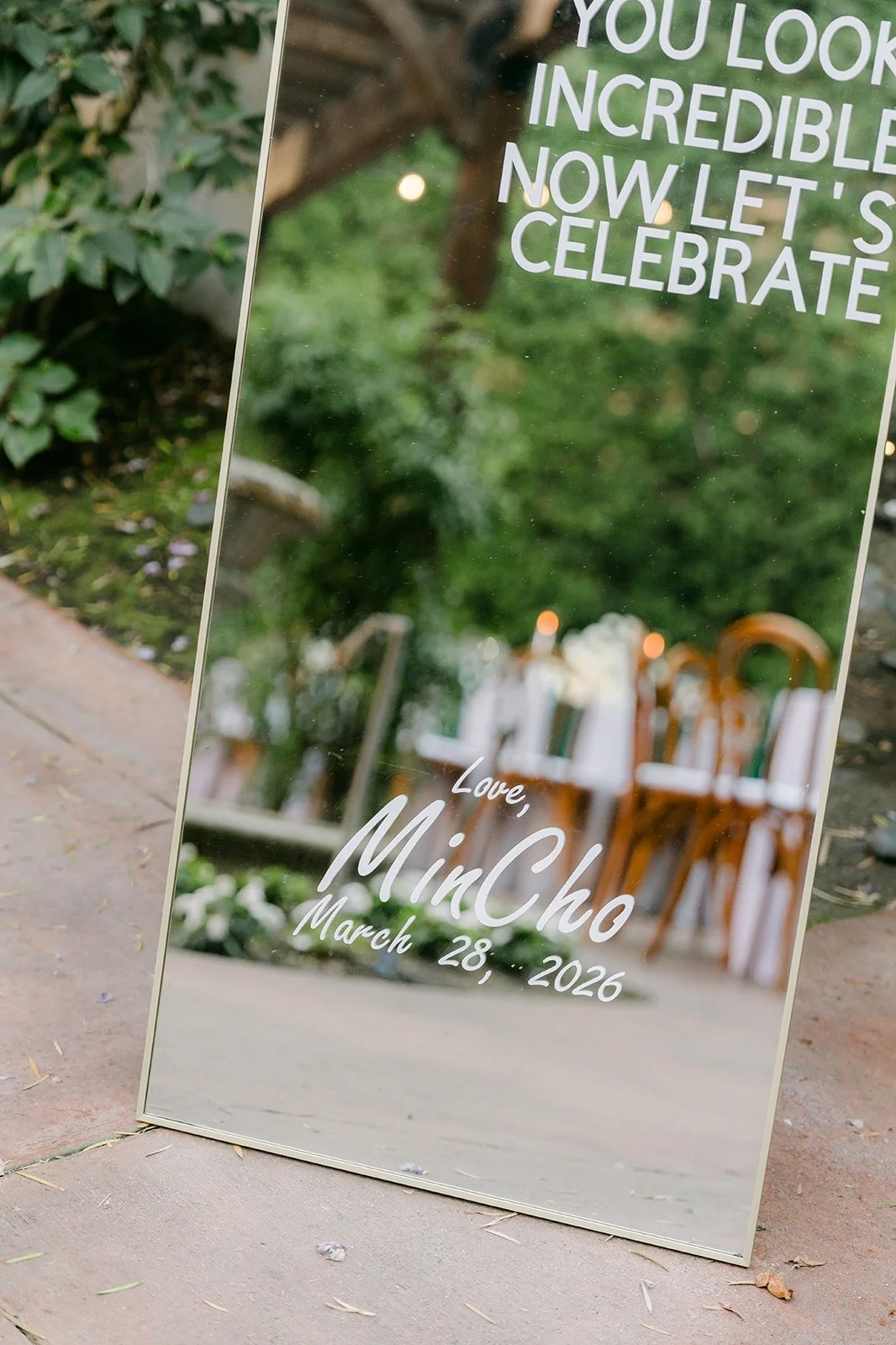 A mirror sign reading "You look incredible, now let's celebrate"