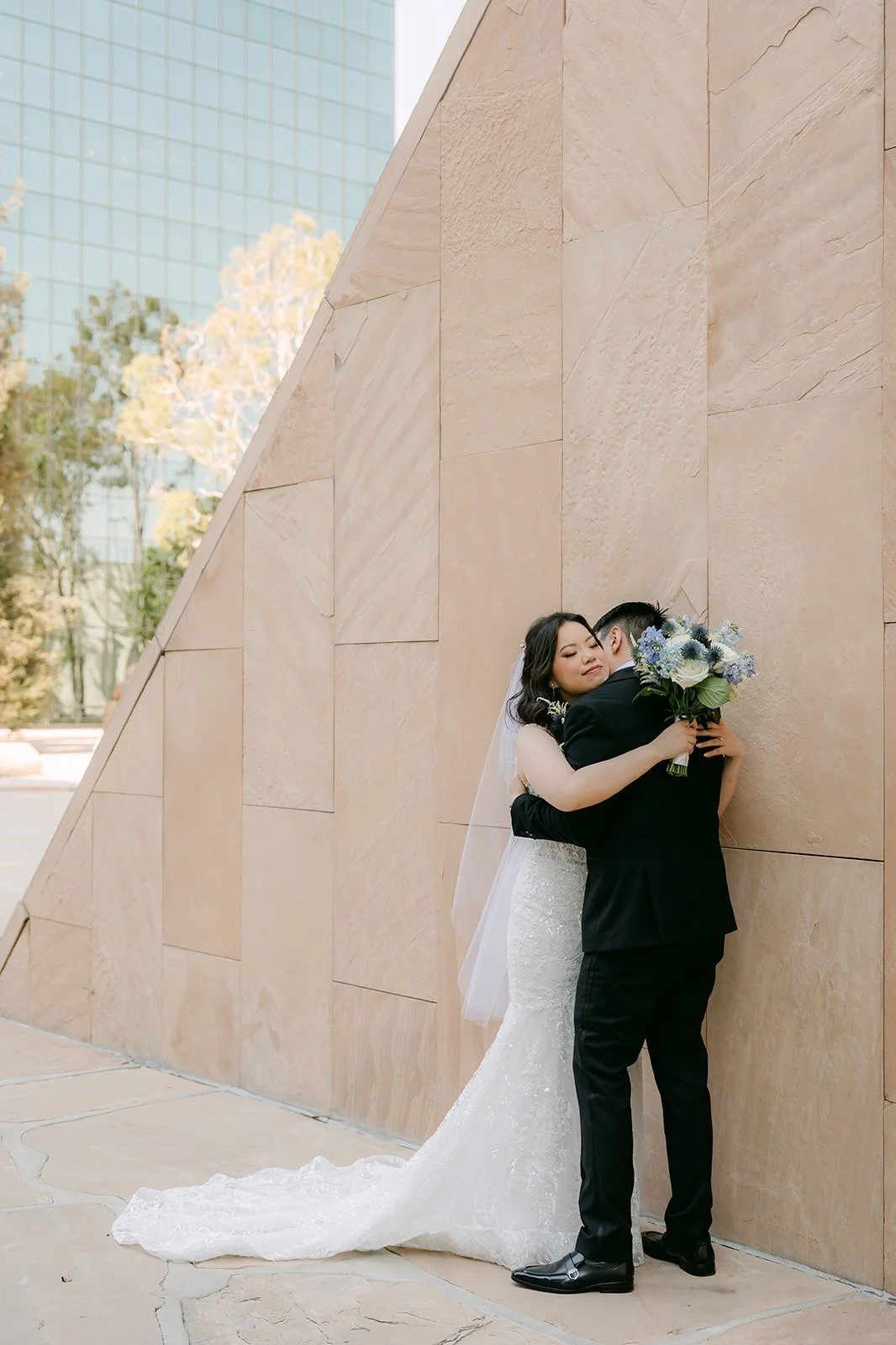 James holding Emily against the sculpture wall