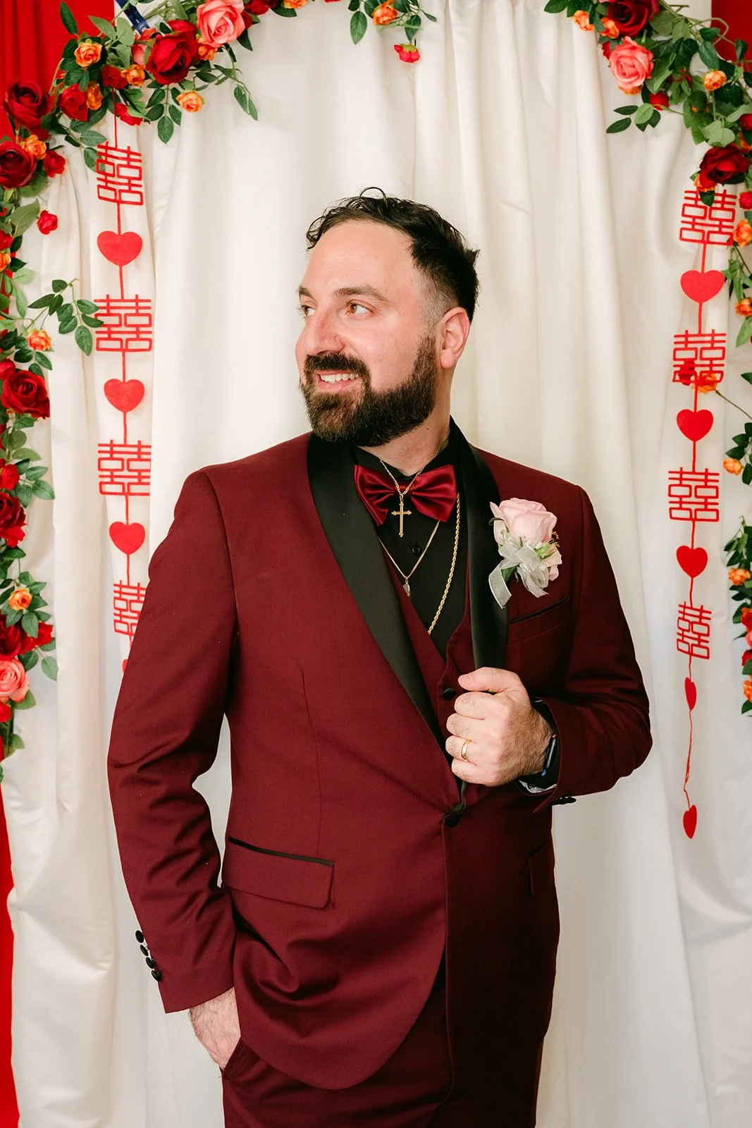 Ryan looking off to the side in his burgundy suit.