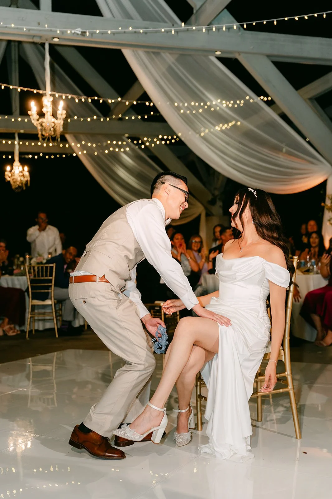 Kevin removing Sandra's garter on the dance floor.