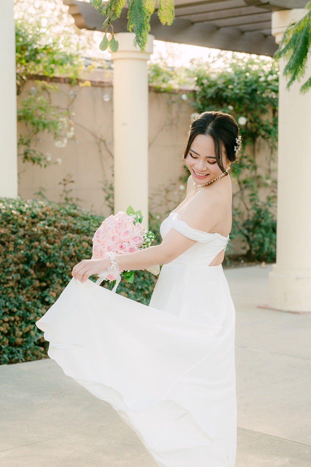 Ivy swishing her skirt beside the columns