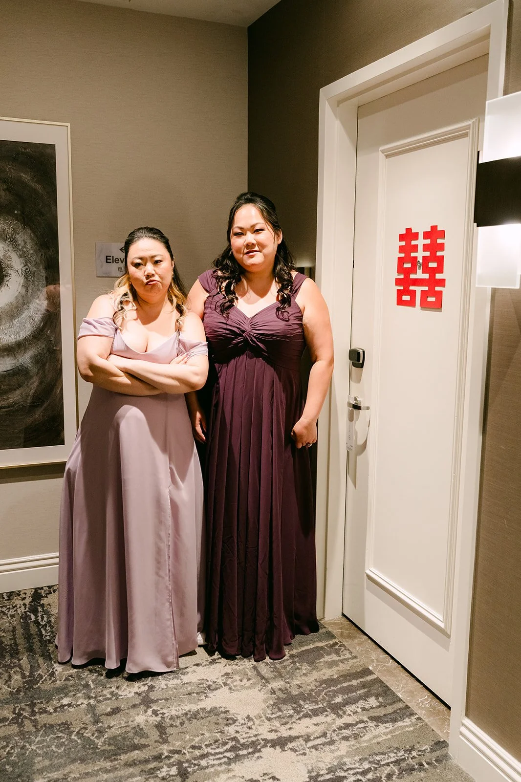 Bridesmaids guarding the door with double happiness signs.