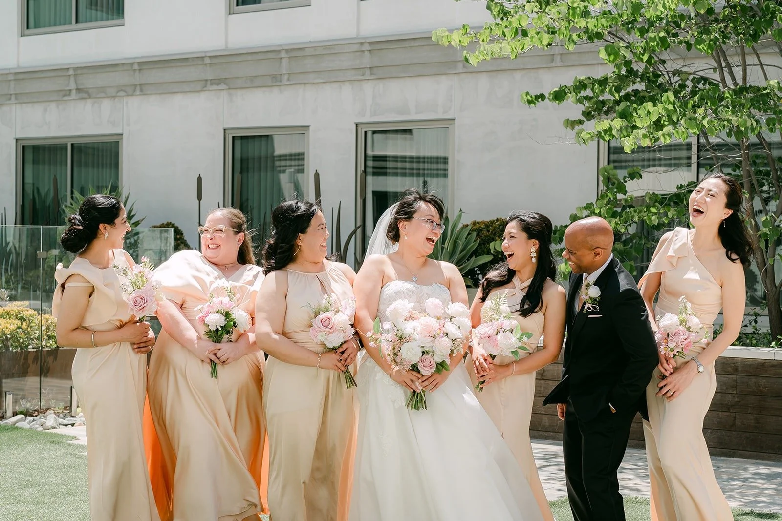 Stella with her bridesmaids in champagne gowns and her bridesman in a black tuxedo