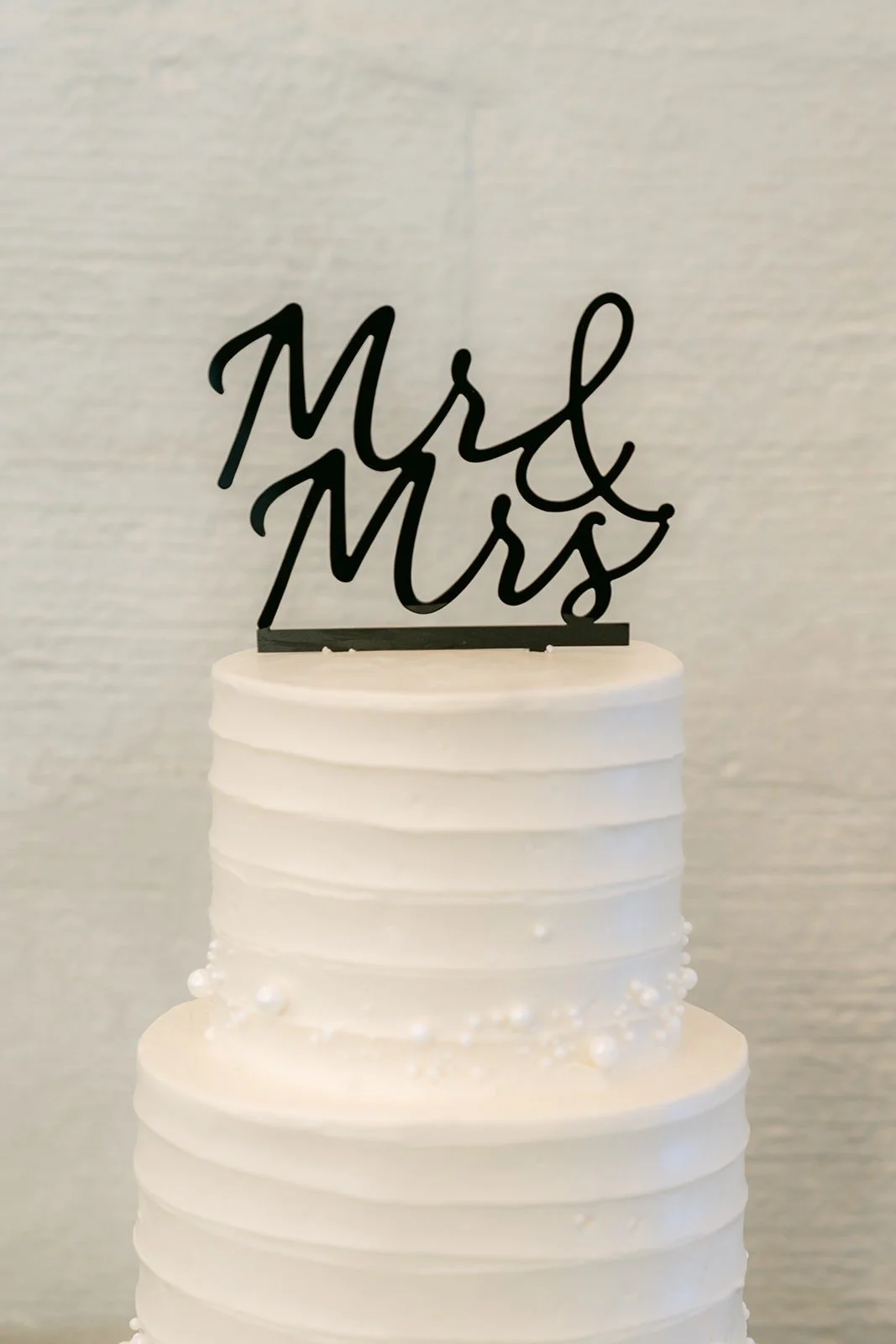 A Mr and Mrs topper on the white cake