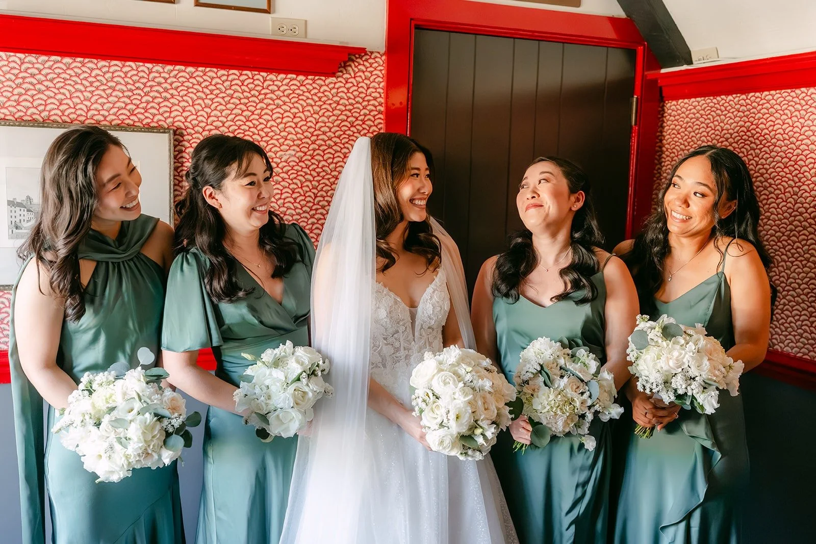 Valerie and her bridesmaids holding white bouquets