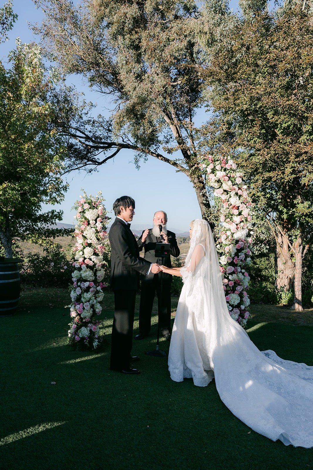 Konitha's long veil trailing behind her at the altar
