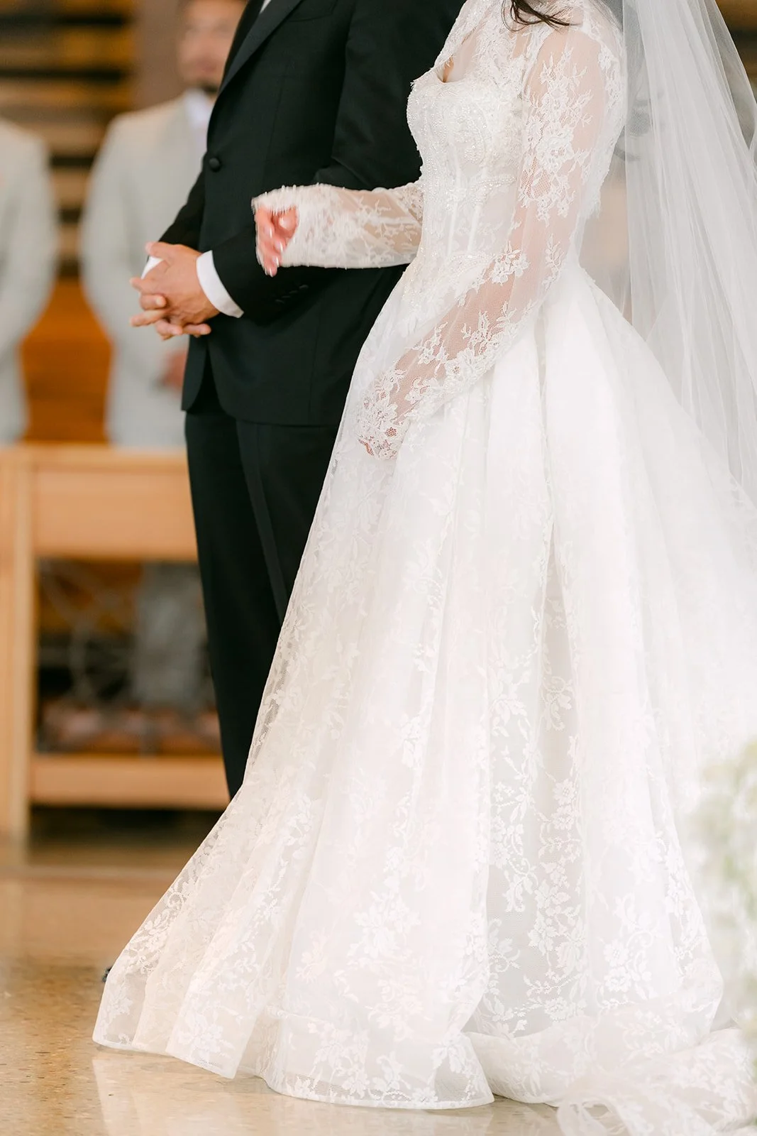 Kim and Vincent holding hands at the altar