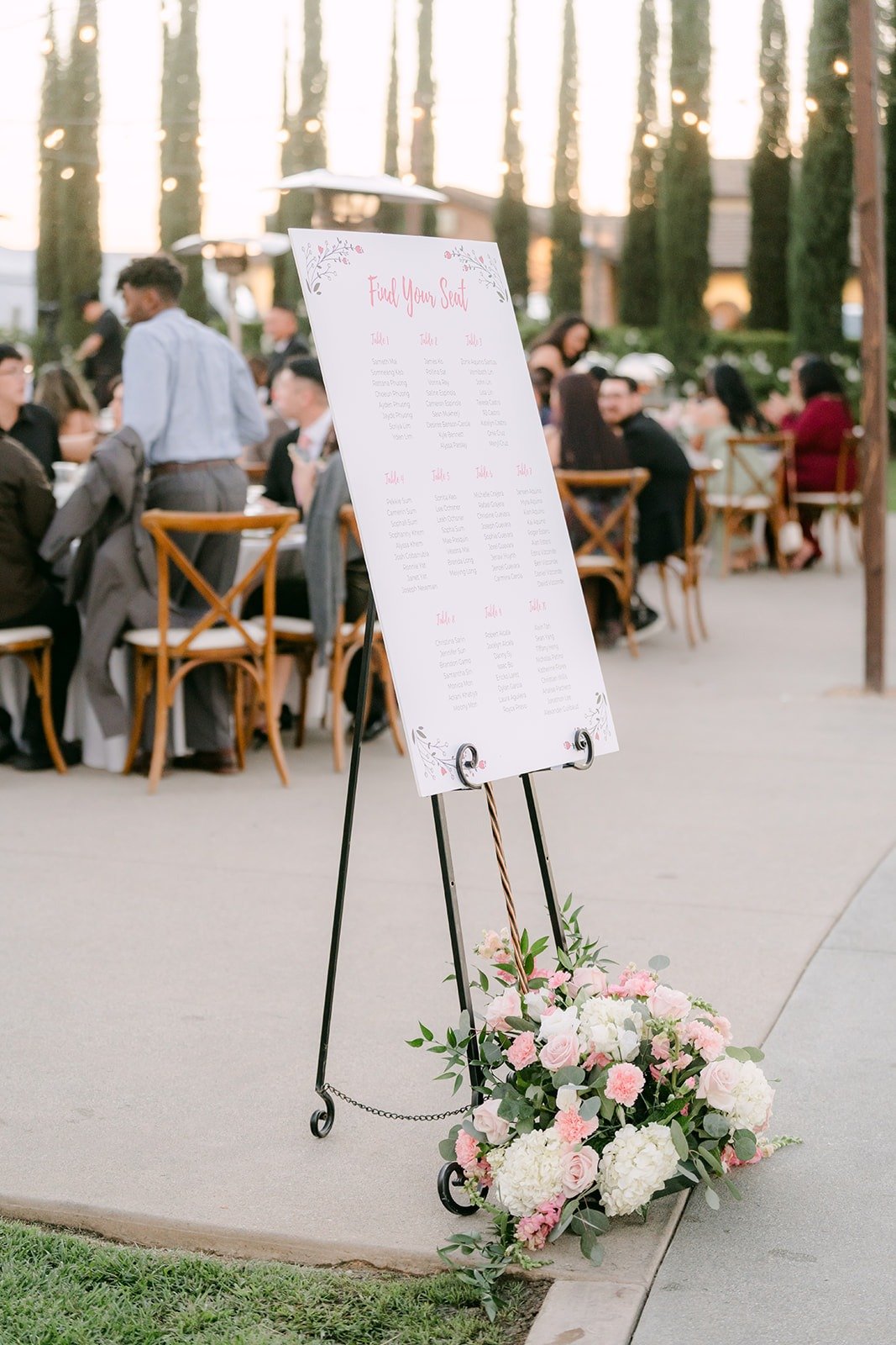 Seating chart easel with blush roses as guests find their seats