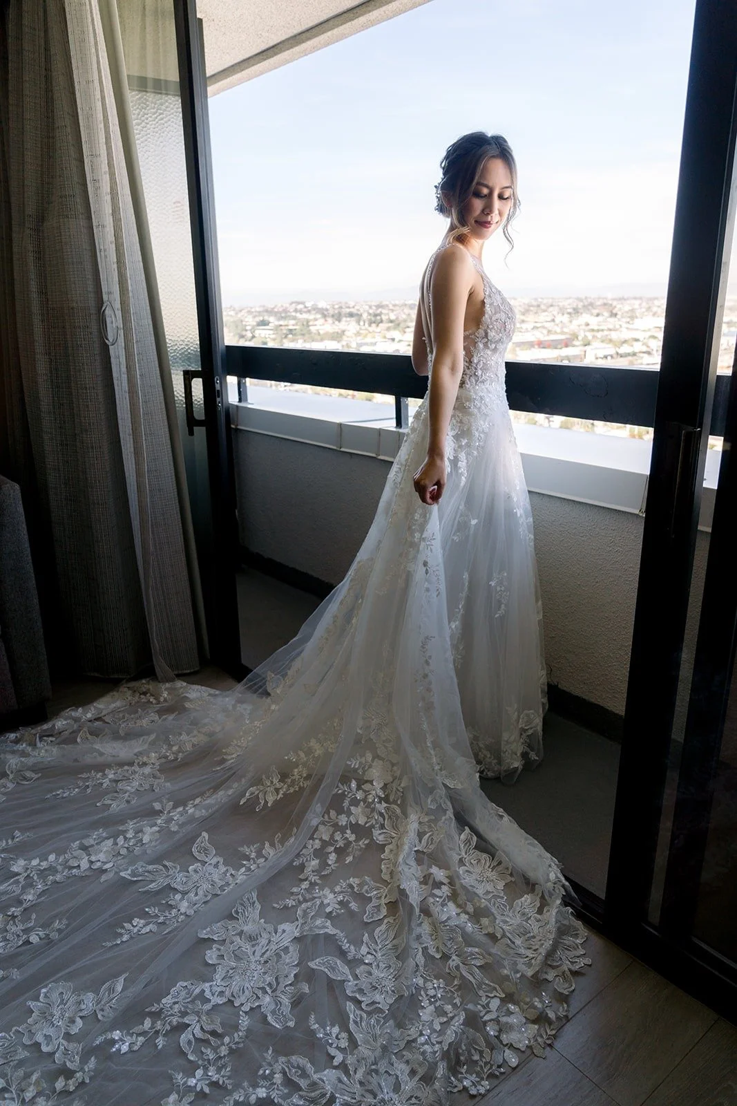 Josephine looking out over the city from the hotel window, photographed by One and Only Production