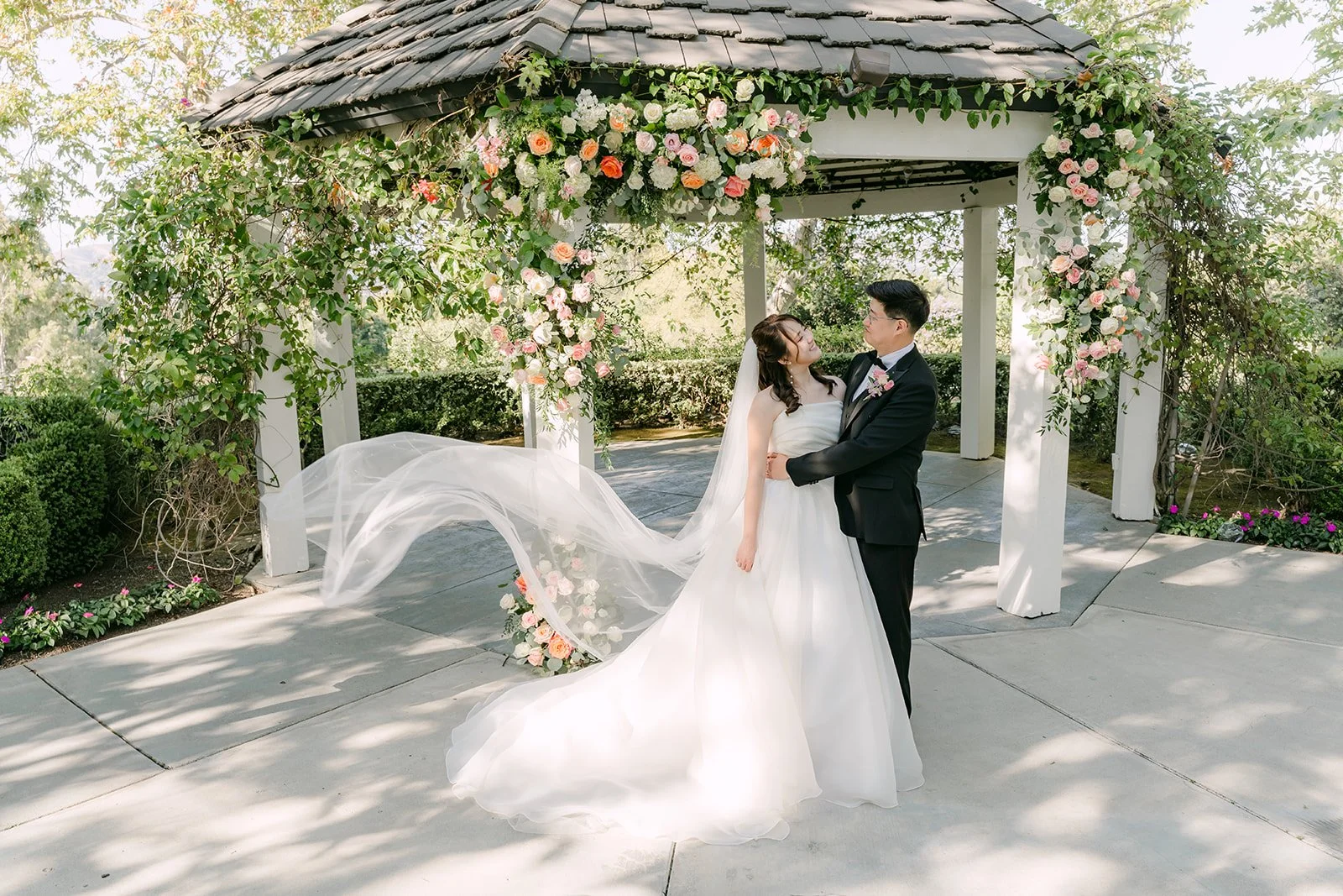 Judy's veil catching the light at the gazebo