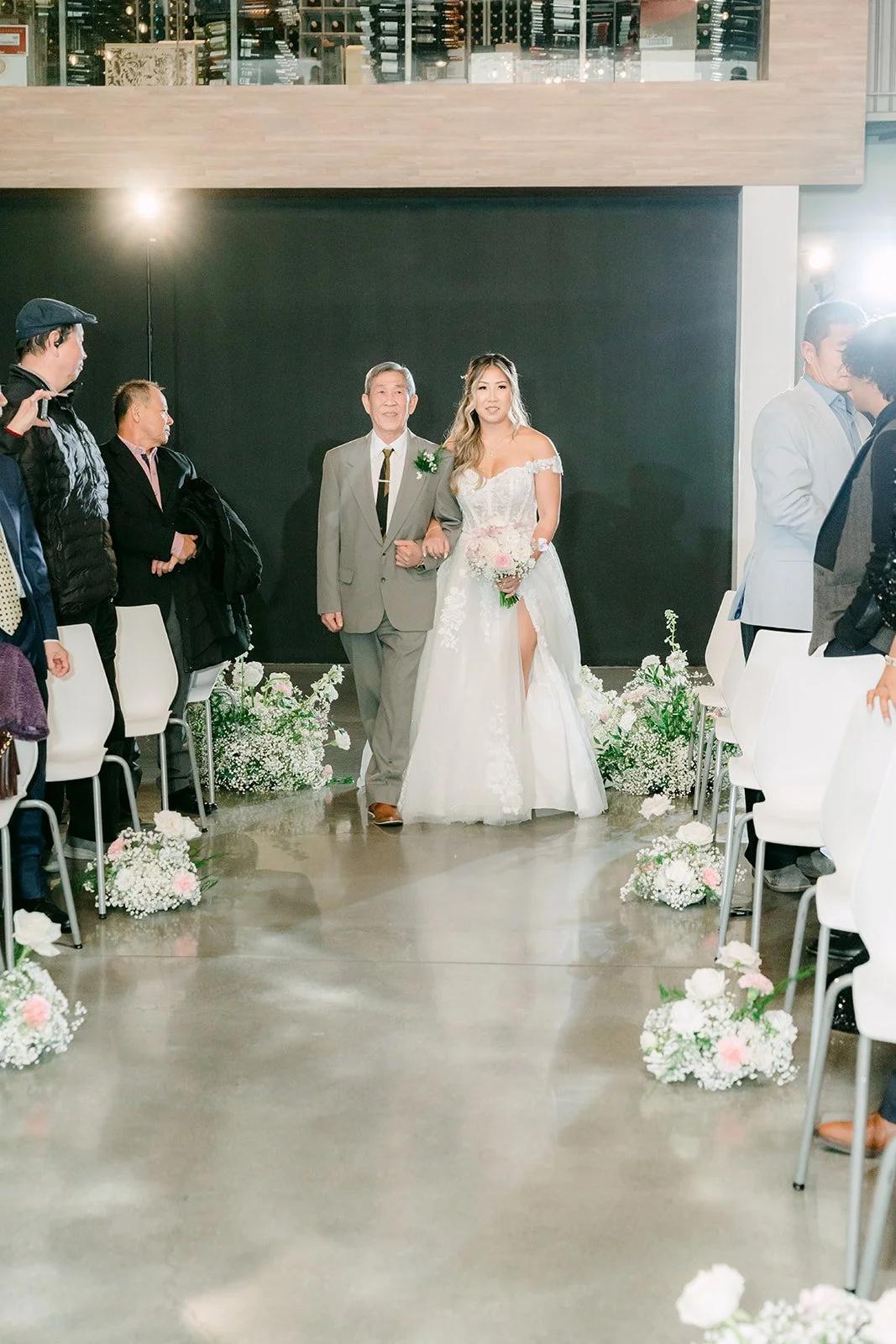 Raine walking down the aisle with her father