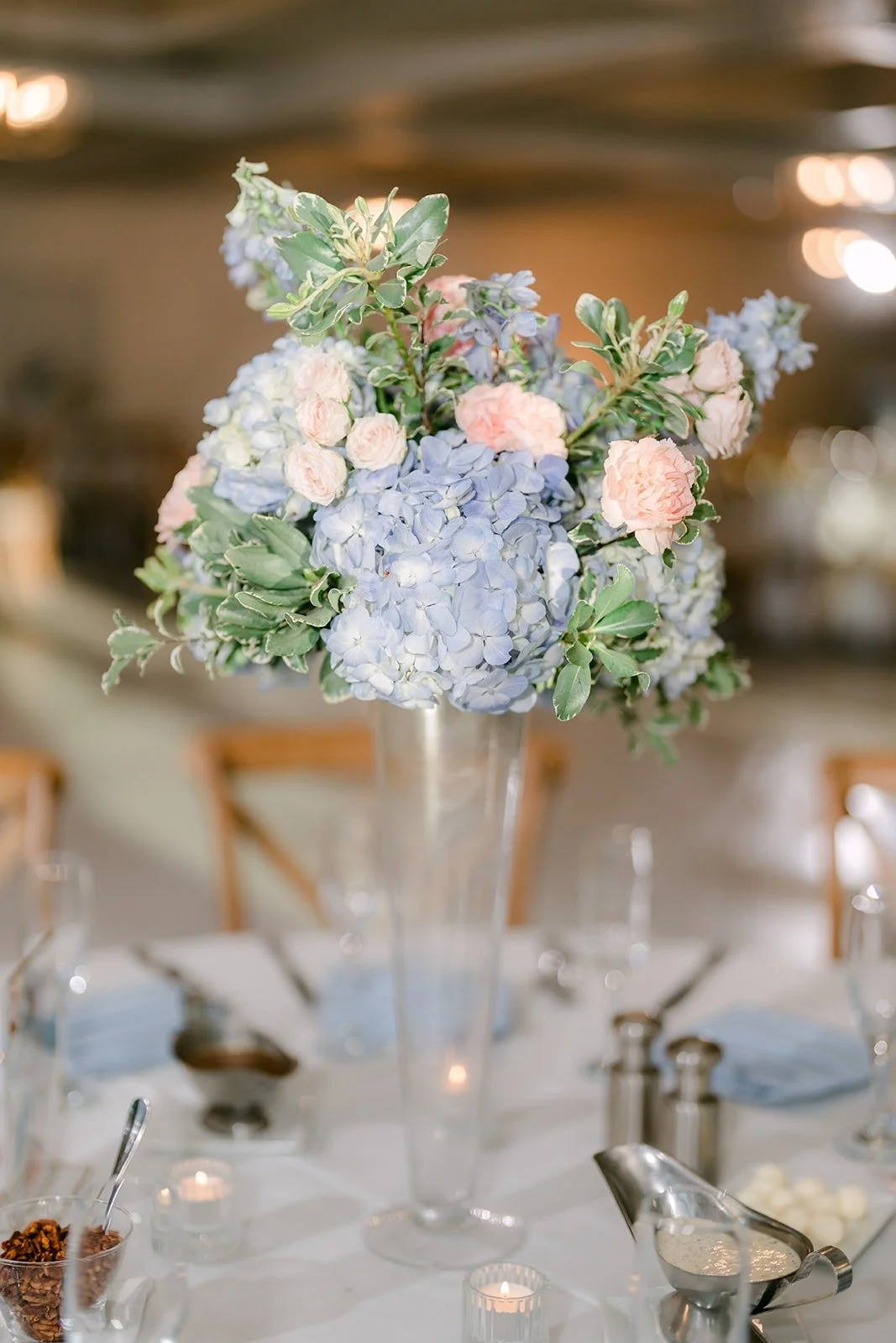 Blue hydrangea centerpiece with glassware on the guest table