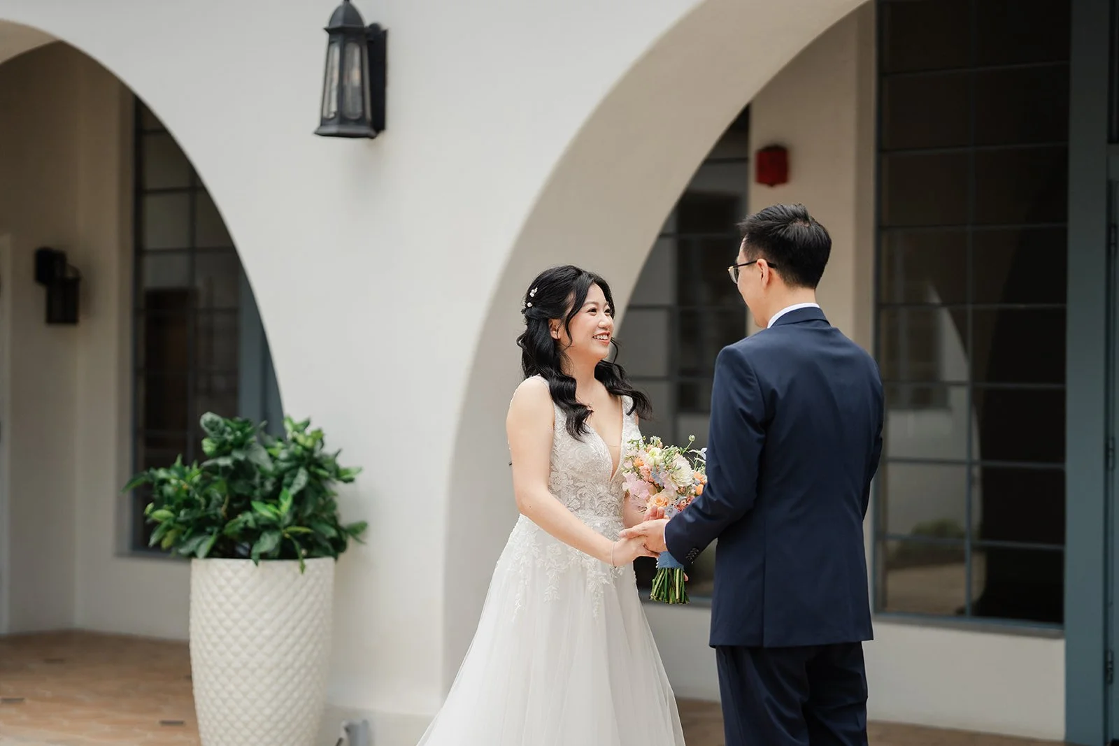 Couple seeing each other under the courtyard arches