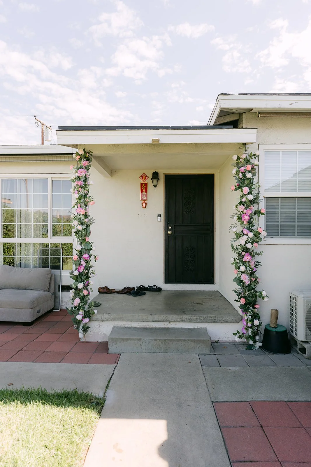 Vanessa's family home in Covina dressed with floral garlands for the tea ceremony.