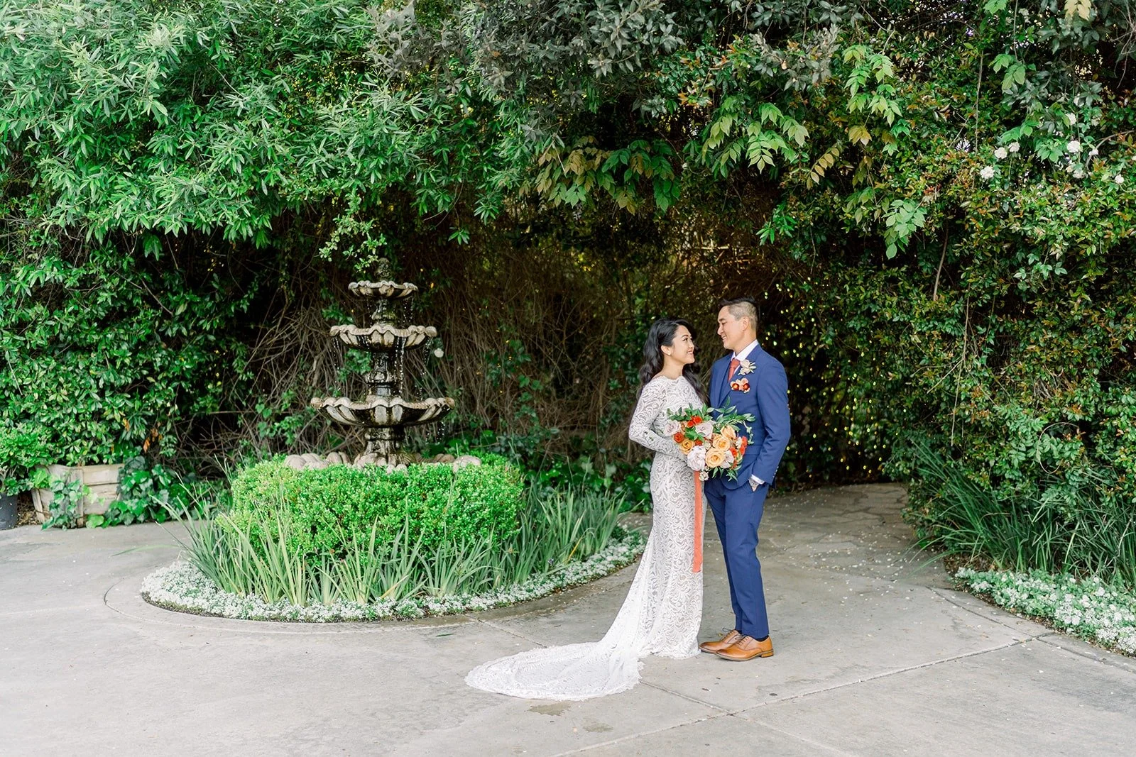 Hannah and Vincent in front of the tiered garden fountain
