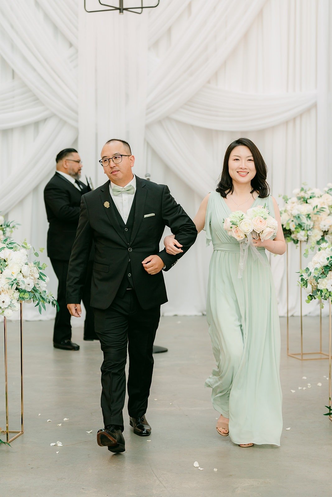A groomsman and bridesmaid walking up the aisle