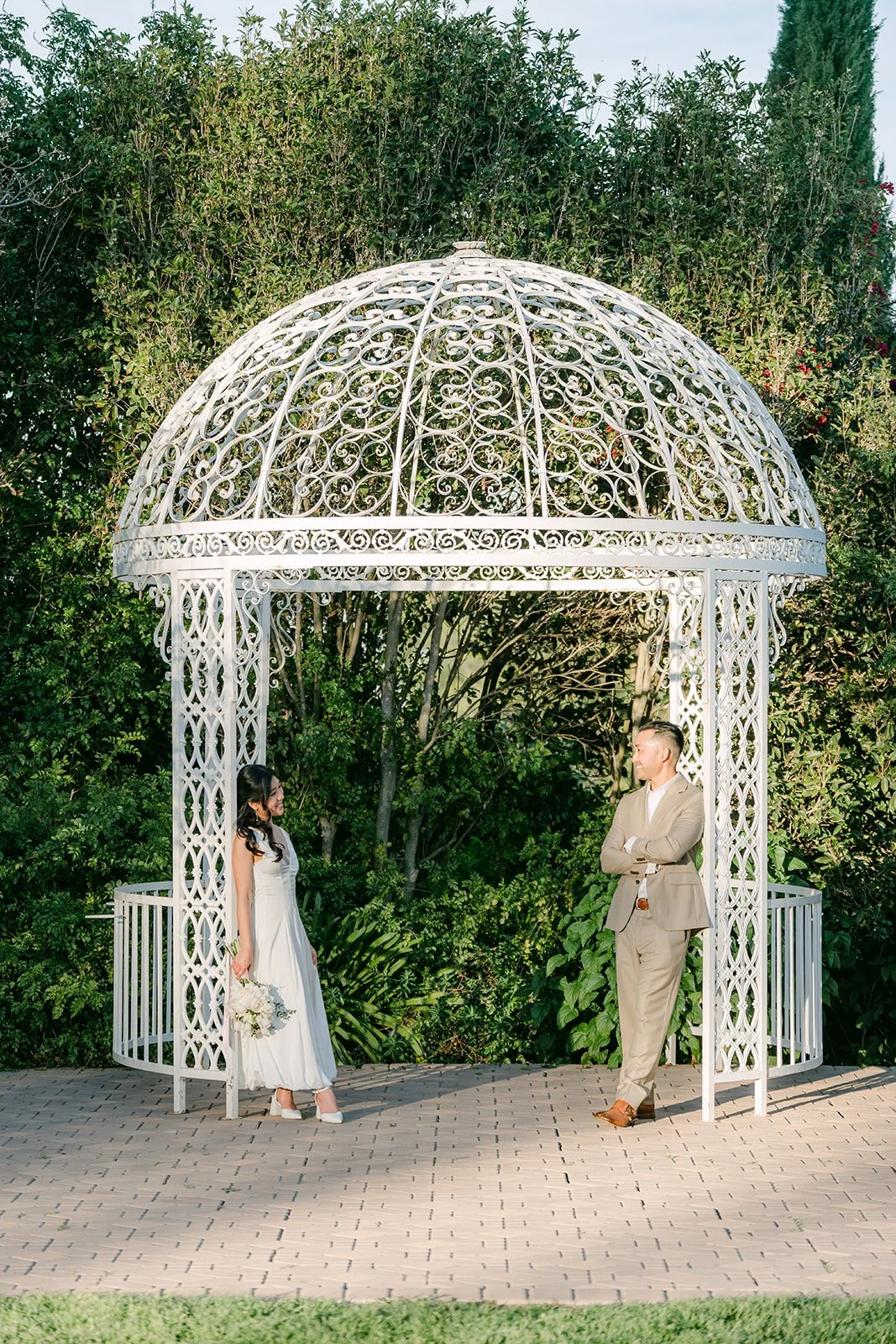 Kim and Vincent facing each other inside the white gazebo.