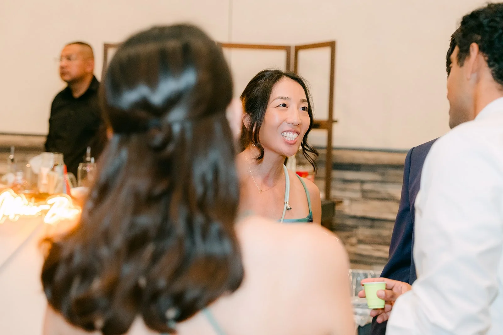 Christie laughing with friends at the end of the night, photographed by One and Only Production.