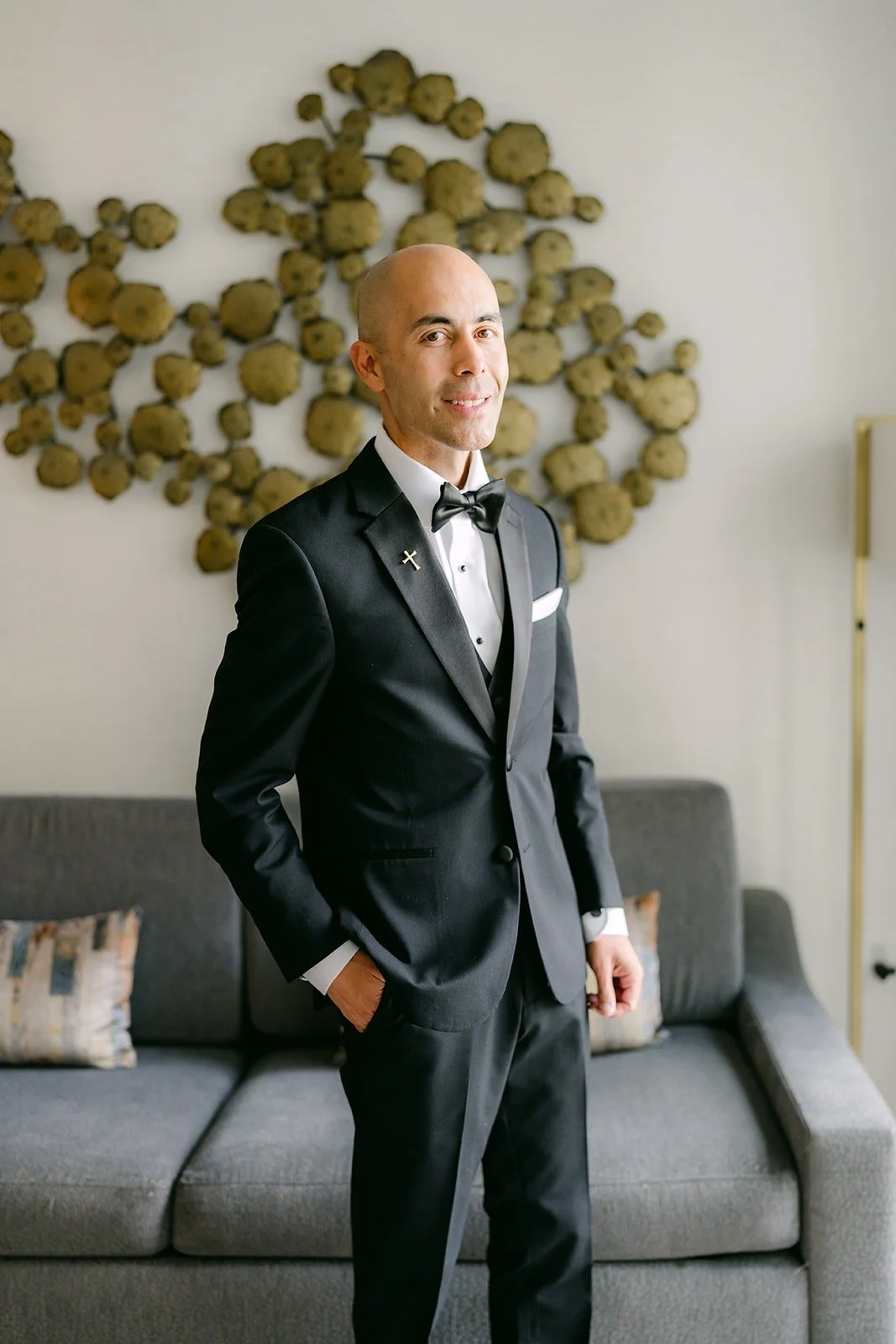 Daniel in his black tuxedo and bow tie in the Groom Suite