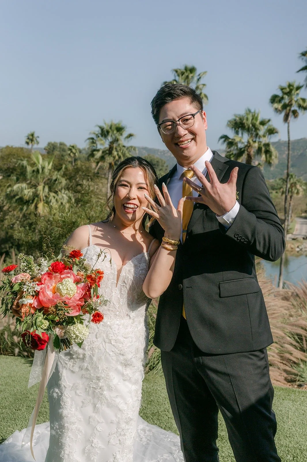 Joanne and Zach laughing together with palm trees and hills behind them