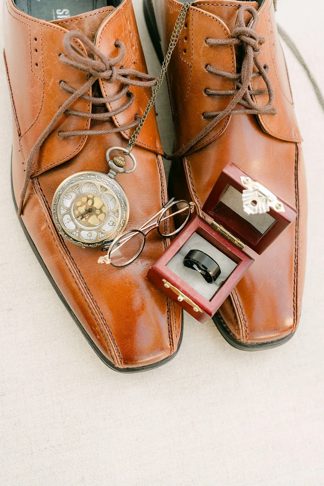 Danny's brown shoes styled with a pocket watch and his ring box for his Padua Hills Theatre wedding