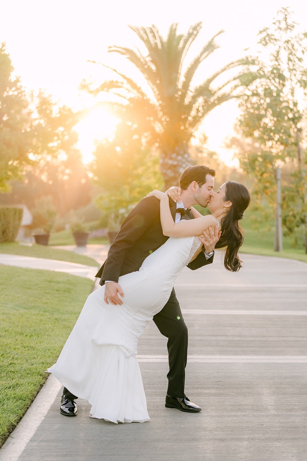 Kevin dipping Stephanie for a kiss on the path at sunset