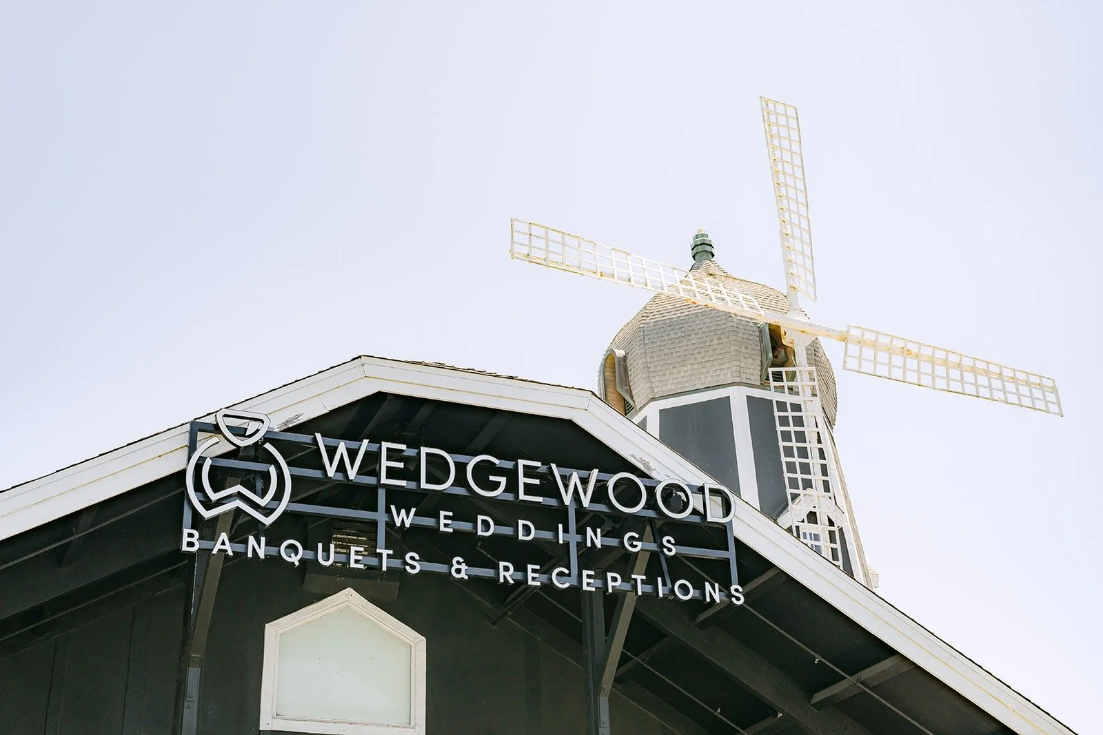 The Wedgewood sign below the Carlsbad Windmill