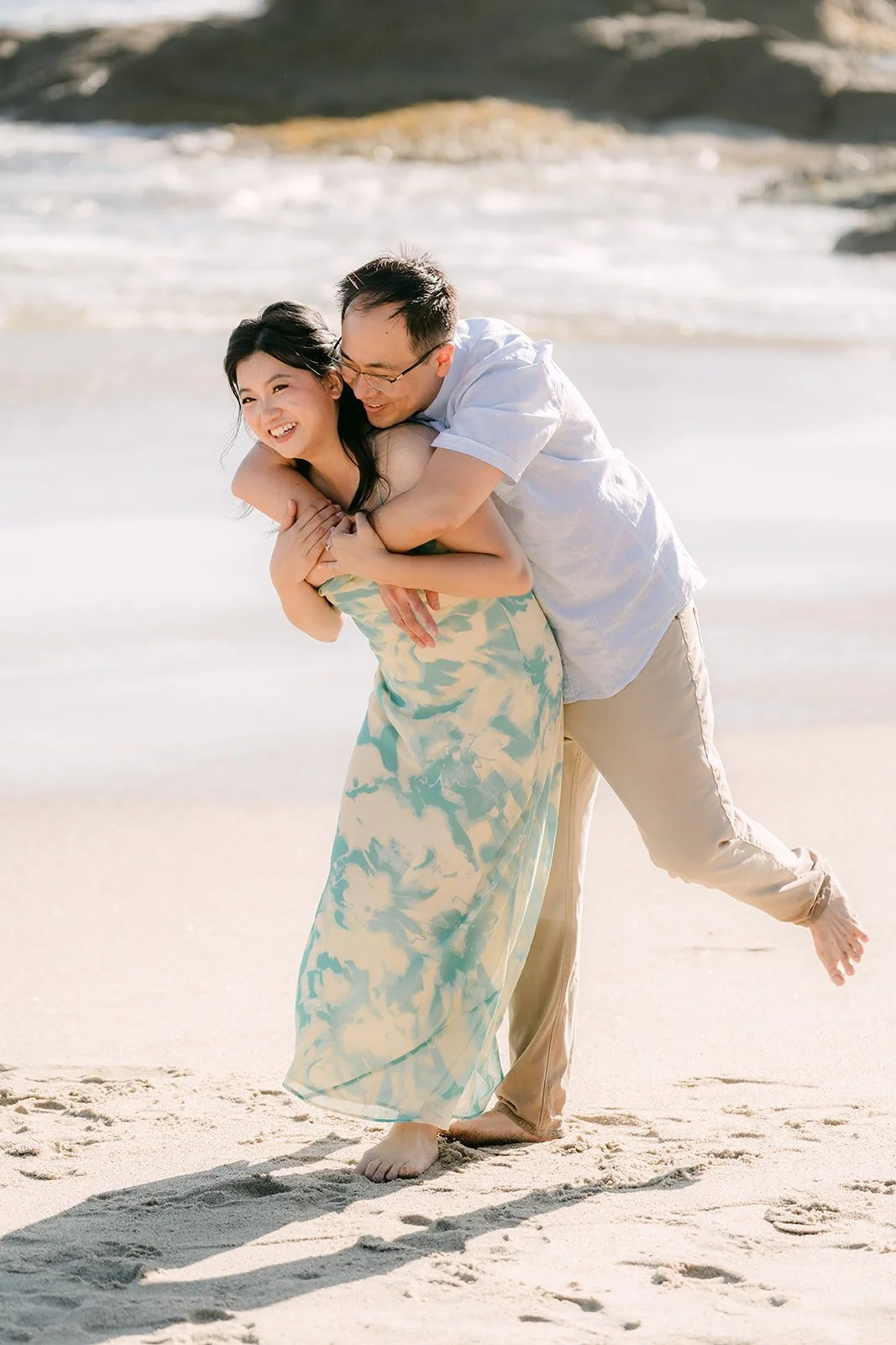 Lawrence lifting Constance off the sand.