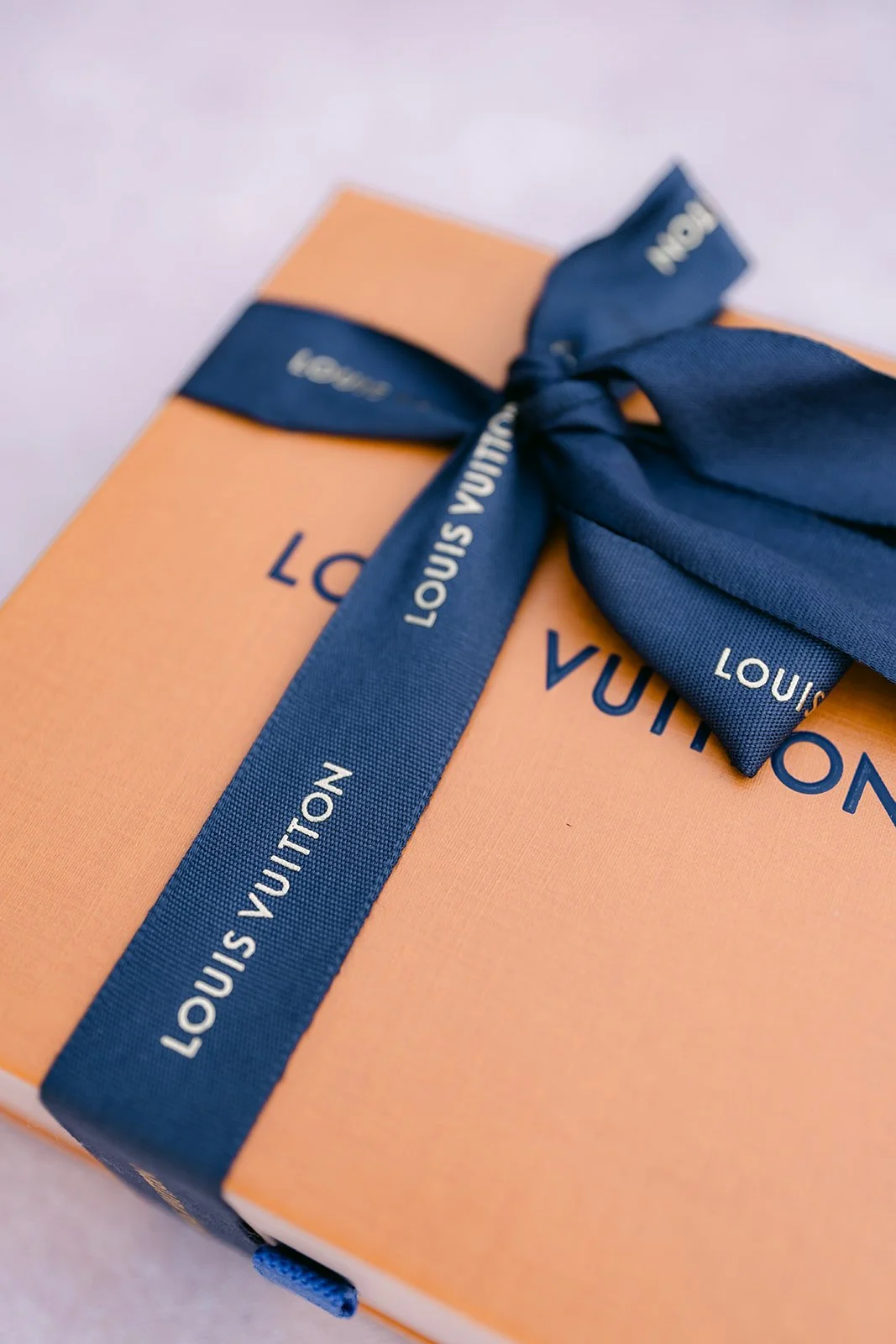 A gift box tied with a navy ribbon for the wedding day.