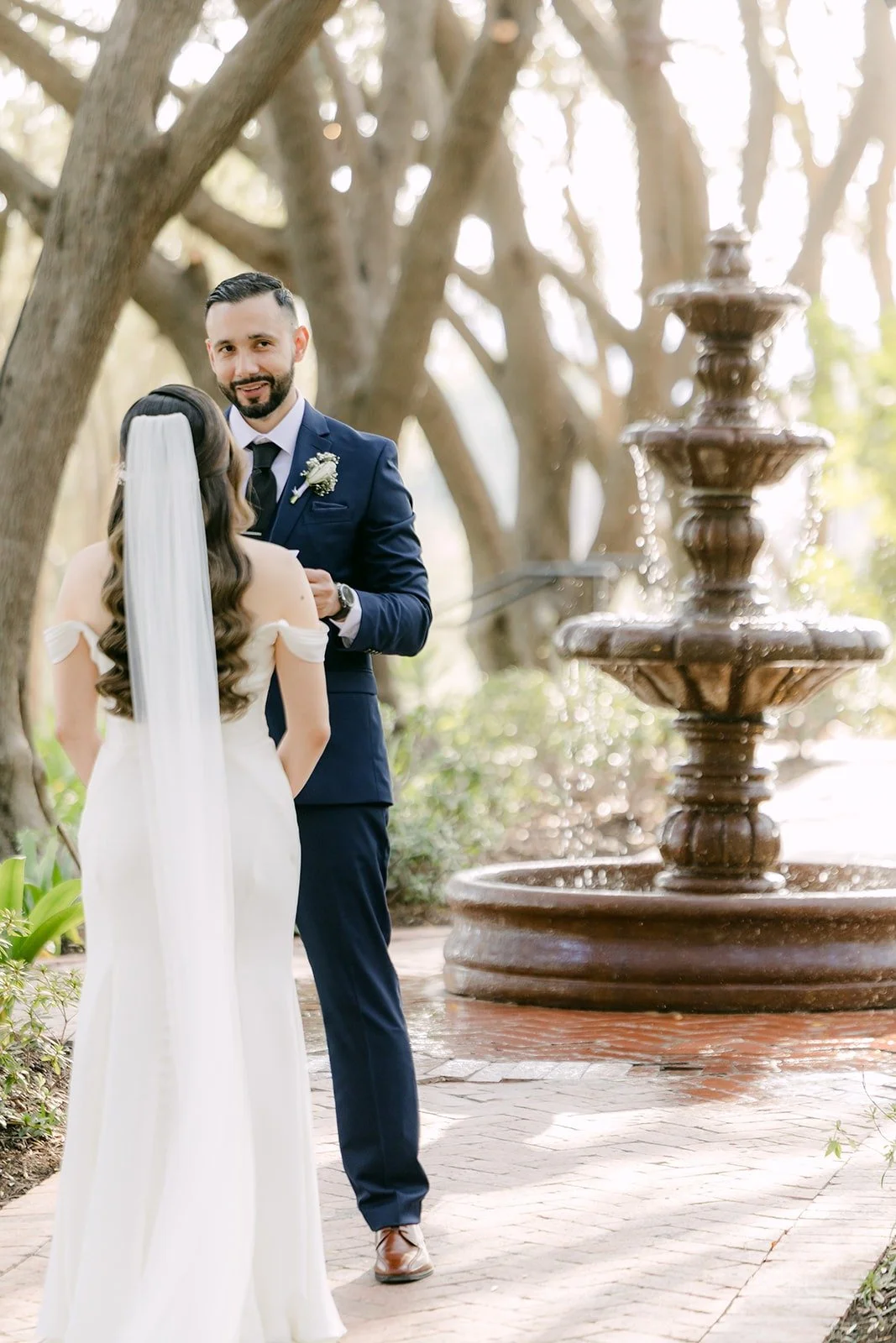 Mariana and Danny beside a tiered fountain at Padua Hills Theatre, photographed by One and Only Production