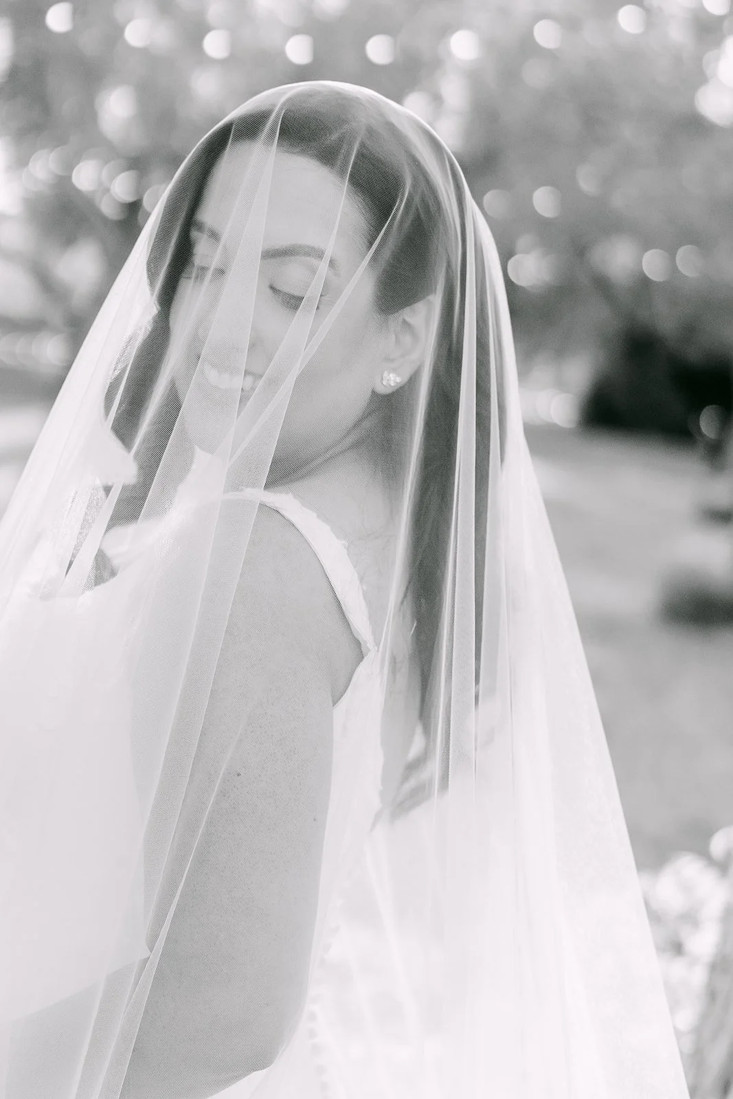 Black and white close up of the bride under her veil