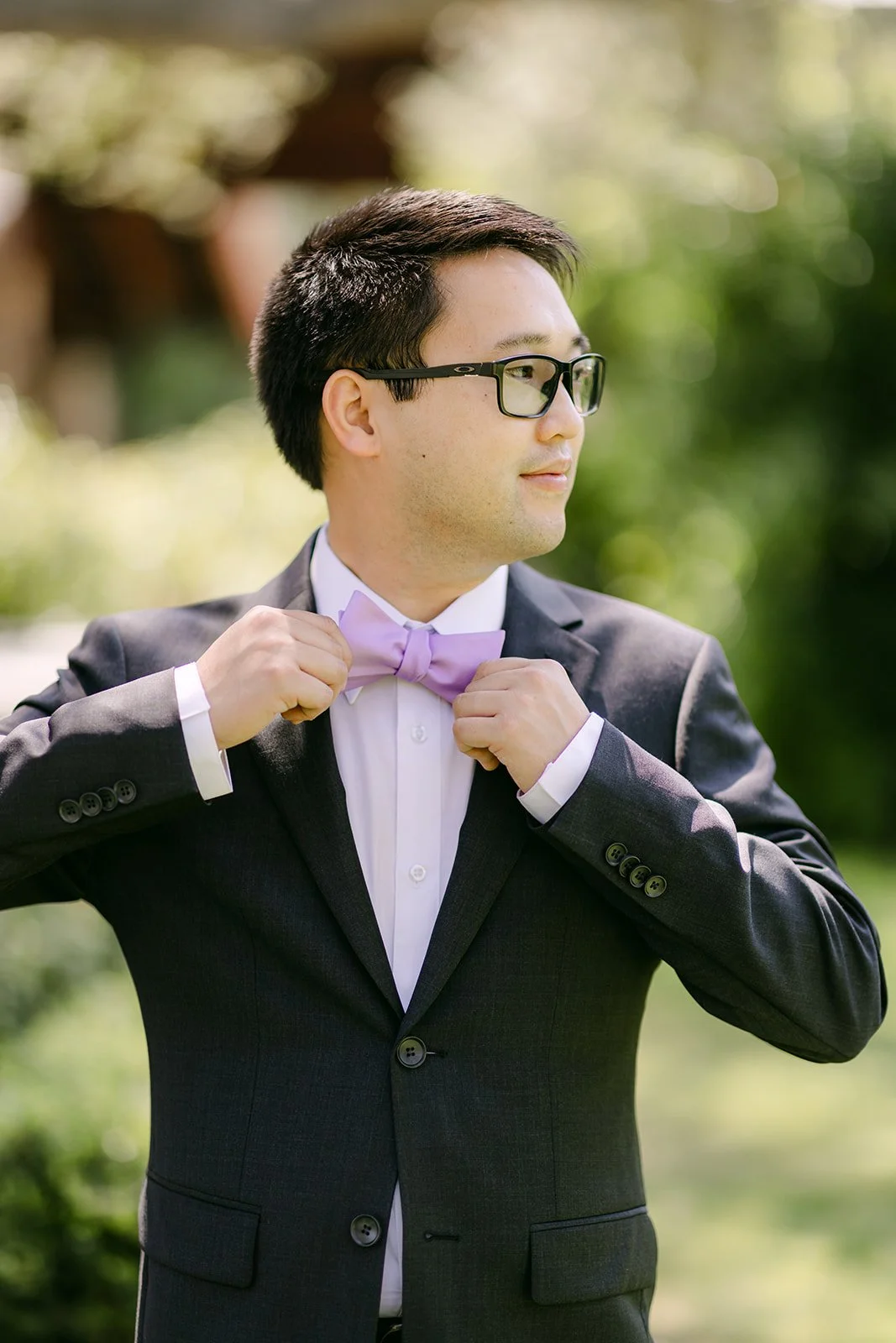 Patrick adjusting his lavender bow tie